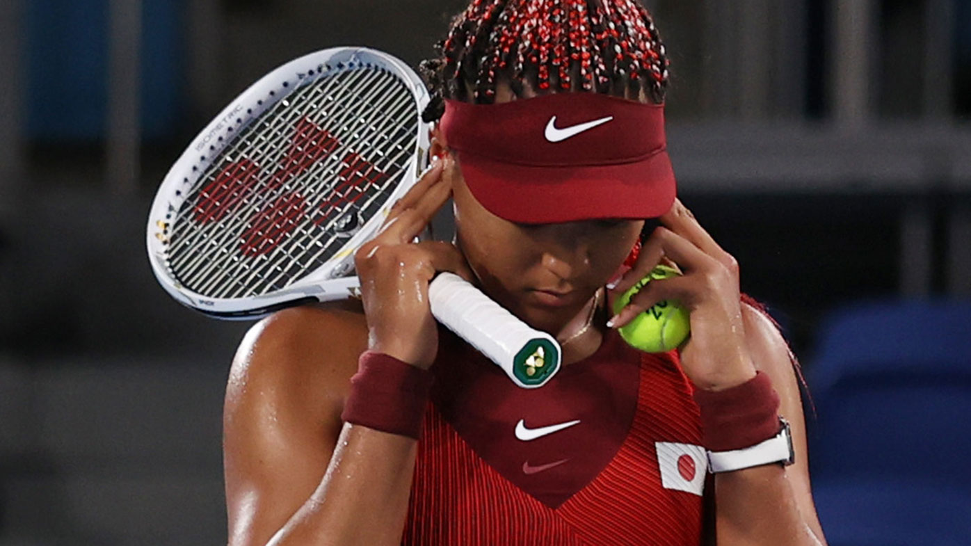 Naomi Osaka covers her ears before match point in her loss to Marketa Vondrousova at the Tokyo Olympics.
