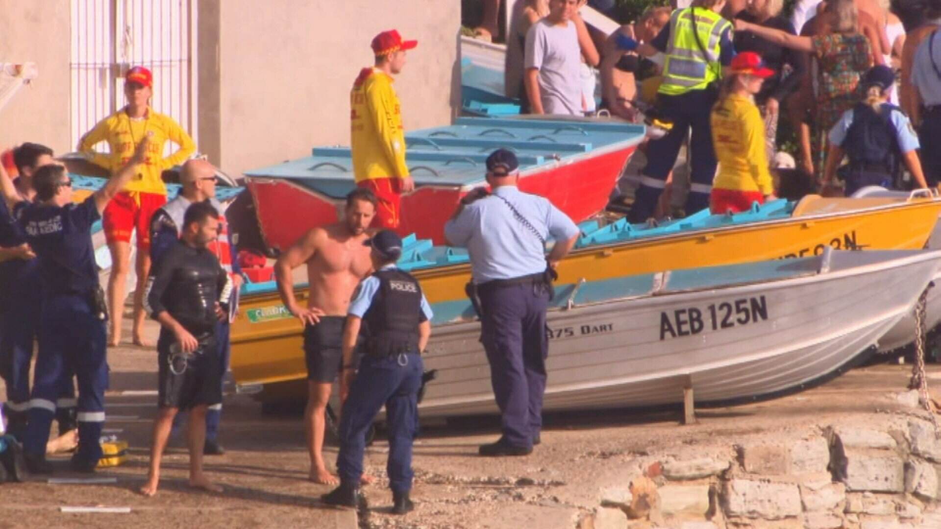 Police and life savers gather on the beach after the Russian DJ drowned.