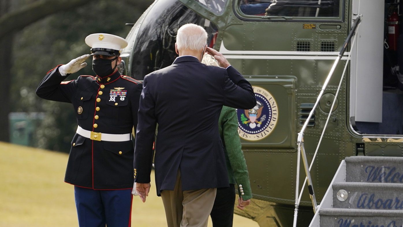 President Joe Biden salutes before boarding Marine One with first lady Jill Biden at the White House in Washington, Friday, Feb. 26, 2021, for a short trip to Andrews Air Force Base, Md., and then on to Houston