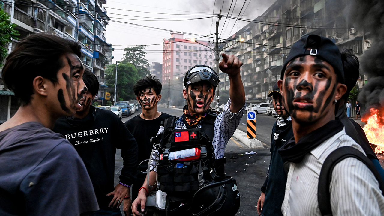 As the United Nations Security Council discussed Myanmar's military coup on Wednesday, the country's junta declared a "ceasefire". Protesters are shown with their faces painted standing near a burning makeshift barricade during a protest against the military coup, in Yangon on Tuesday.