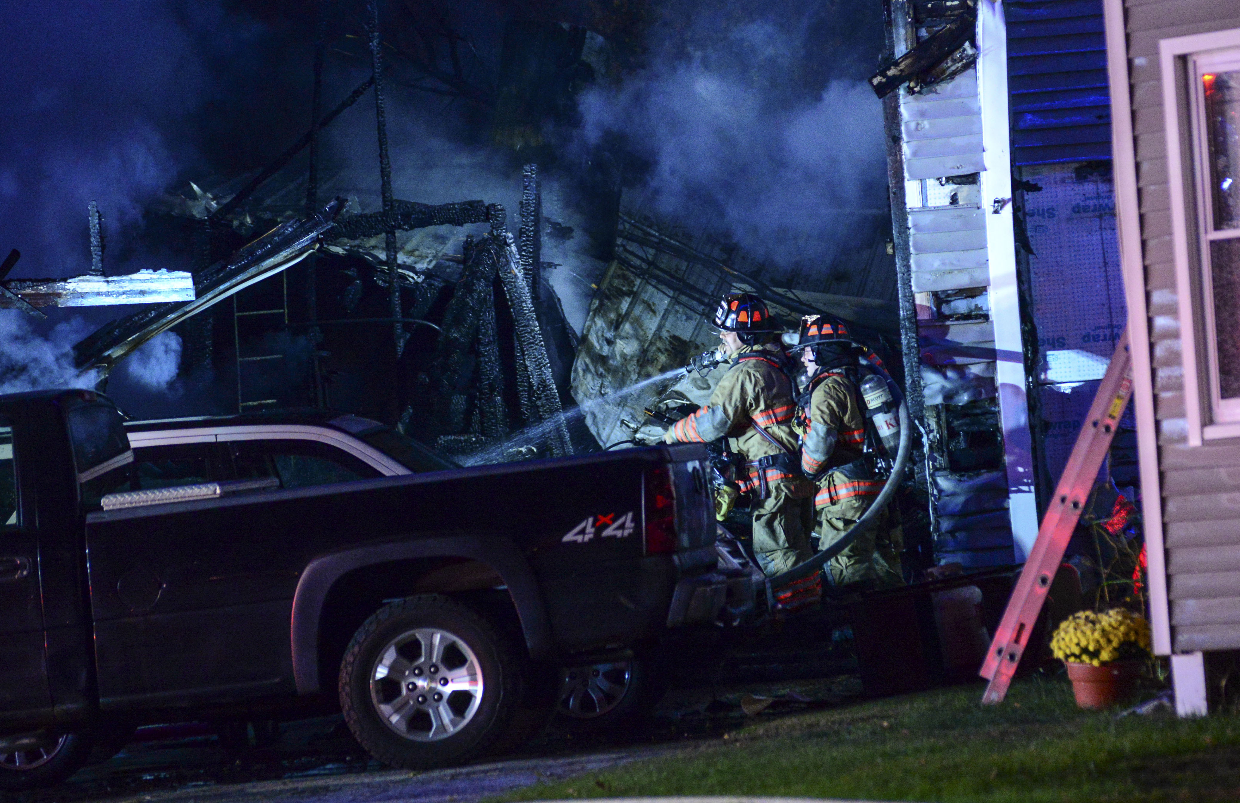 Firefighters work after a single-engine plane crashed Friday, Oct. 21, 2022, in Keene, N.H.  