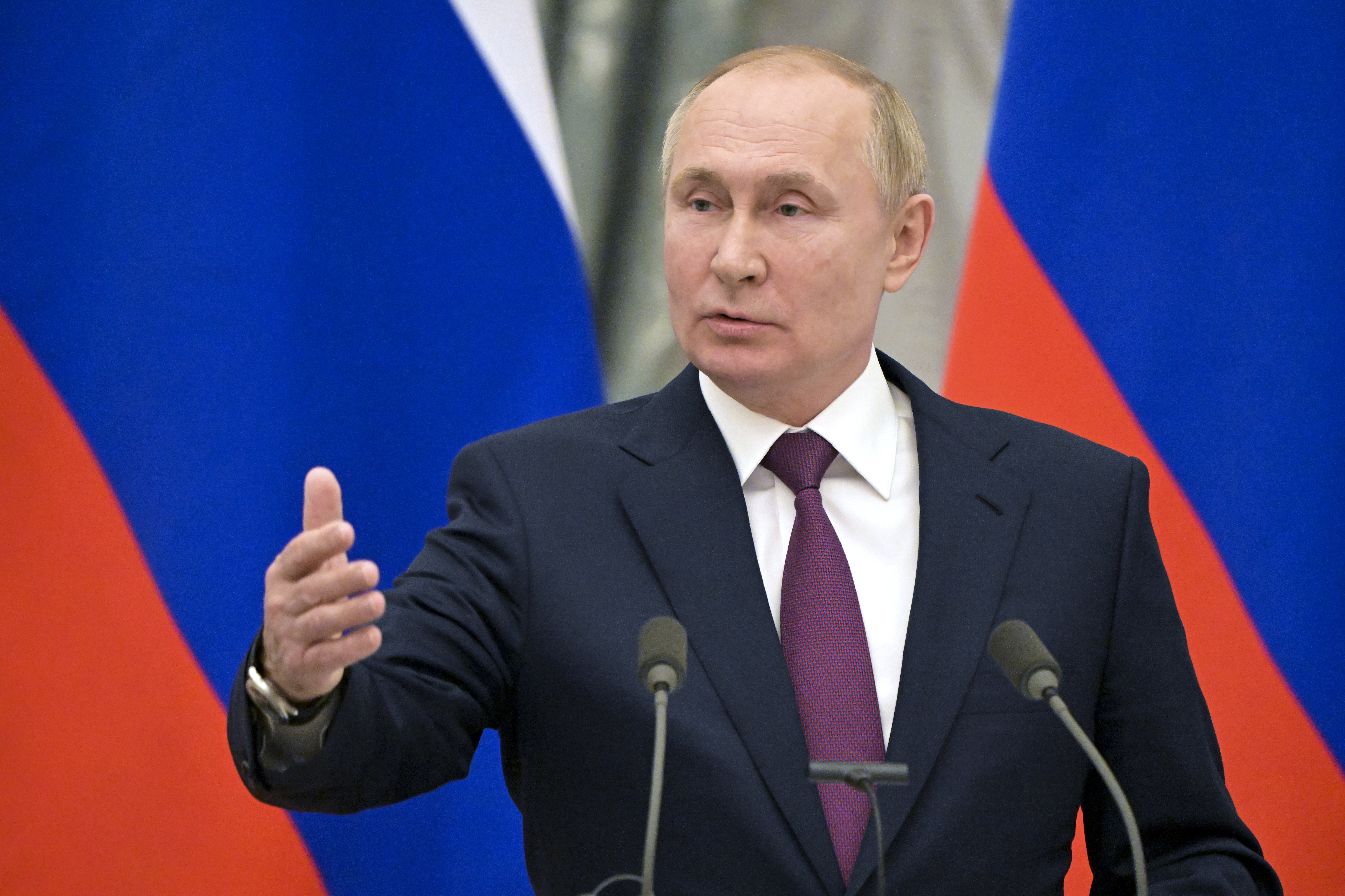 Russian President Vladimir Putin gestures as he speaks during a joint news conference with German Chancellor Olaf Scholz following their talks in the Kremlin in Moscow, Russia, Tuesday, Feb. 15, 2022. 