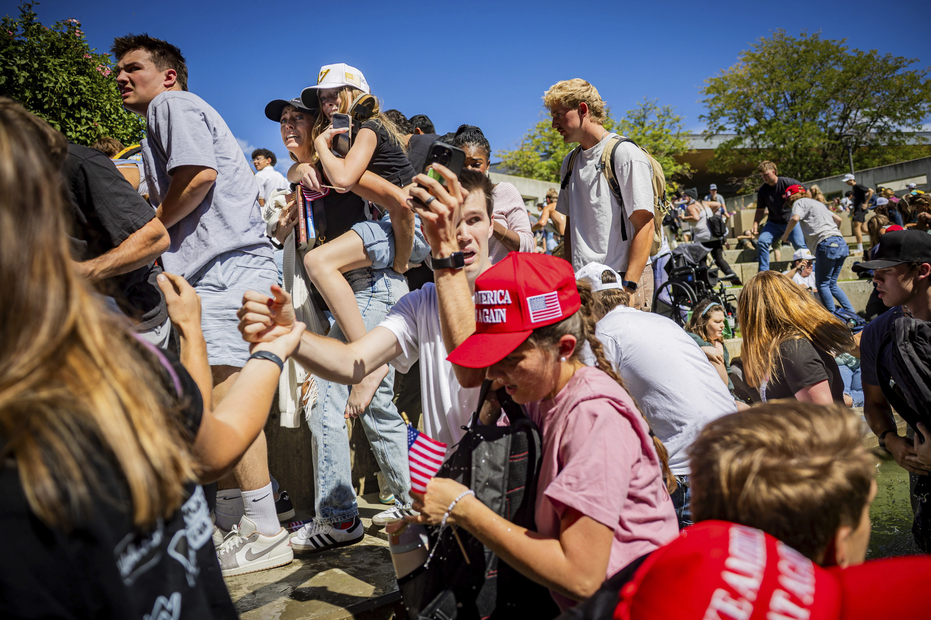 The crowd reacts after Charlie Kirk, the CEO and co-founder of the conservative youth organization Turning Point USA, is shot at the Utah Valley University Wednesday, Sept. 10, 2025, in Orem, Utah. (Tess Crowley/The Deseret News via AP)