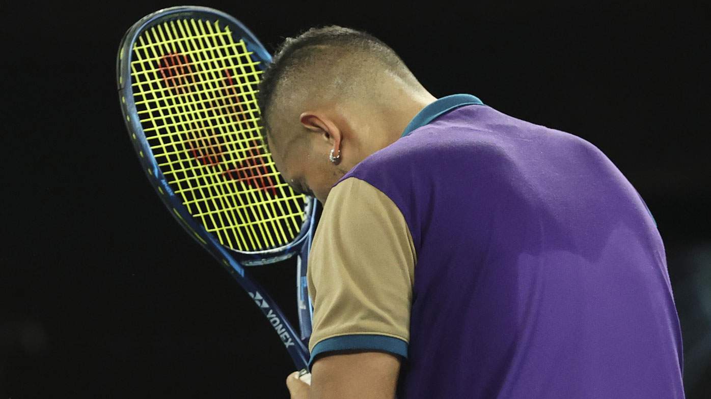 Australia's Nick Kyrgios hits his head with the racquet after losing a point during his third round match against Austria's Dominic Thiem at the Australian Open tennis championship in Melbourne, Australia, Friday, Feb. 12, 2021