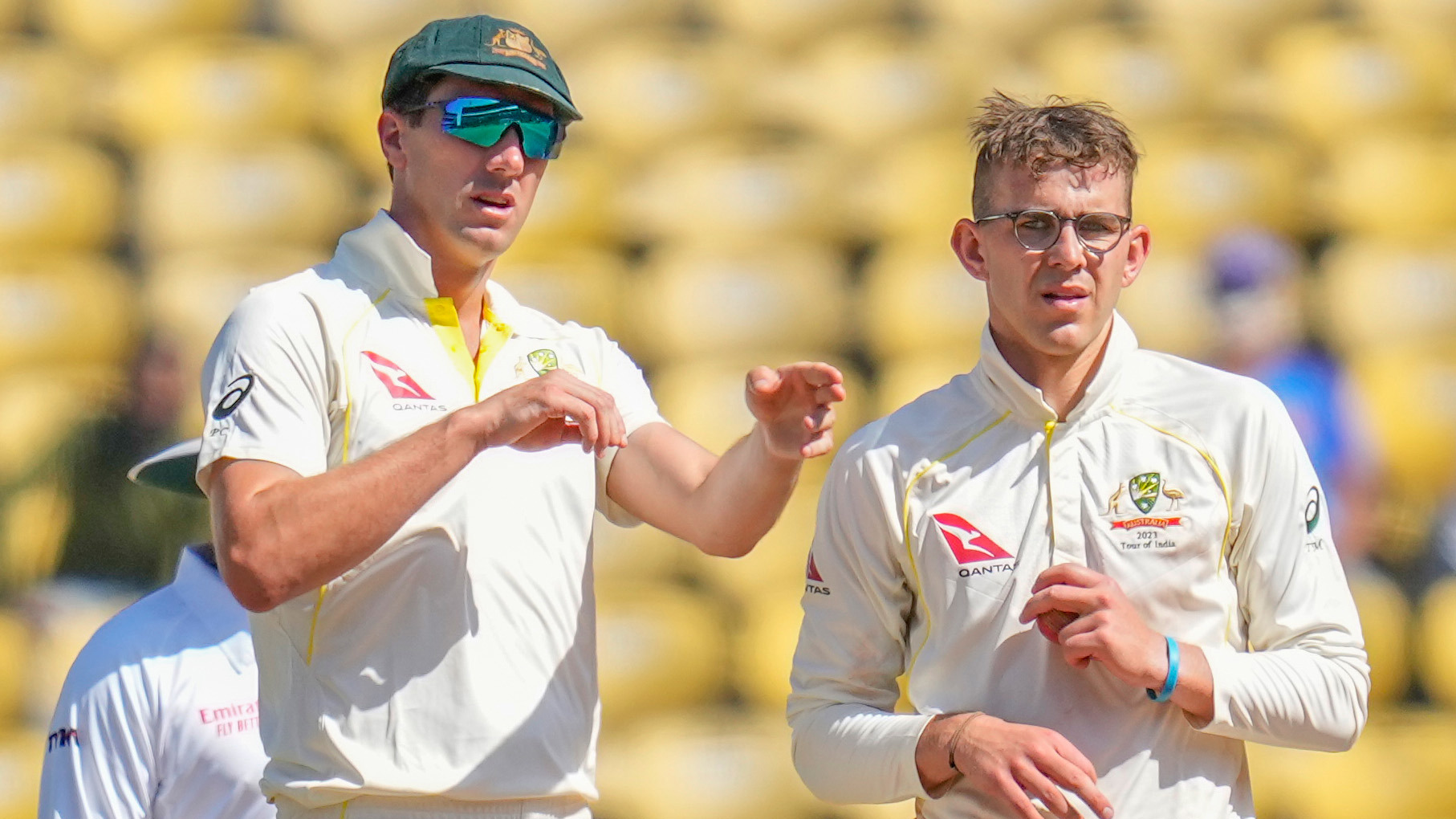 Australia's captain Pat Cummins, left, adjusts fielding as Todd Murphy watches during the third day of the first cricket test match between India and Australia in Nagpur, India, Saturday, Feb. 11, 2023. (AP Photo/Rafiq Maqbool)