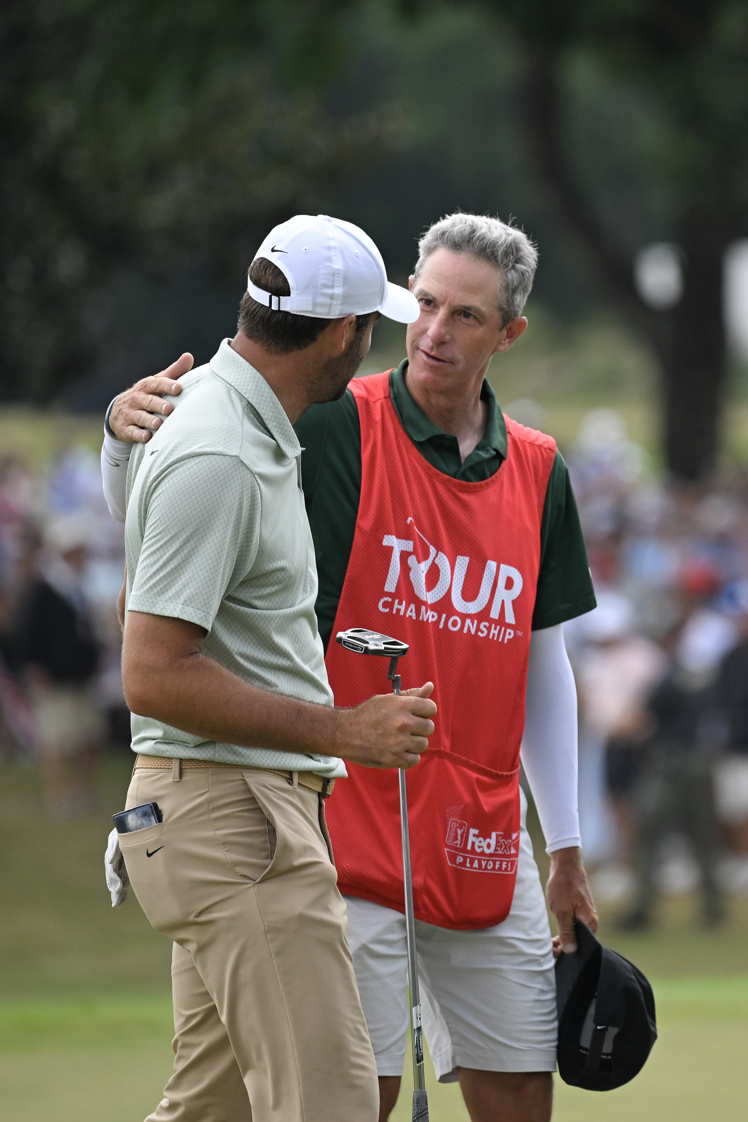 Scottie Scheffler of the United States hugs caddie Ted Scott after winning the TOUR Championship at East Lake Golf Club on September 01, 2024 in Atlanta, Georgia. (Photo by Ben Jared/PGA TOUR via Getty Images)