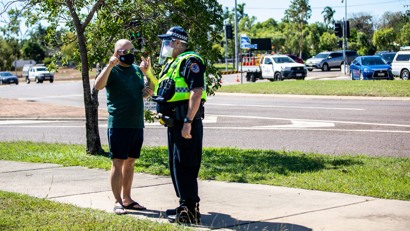 A man talks to a policeman outside a COVID-19 testing station at Marrara Sport Complex in Darwin.