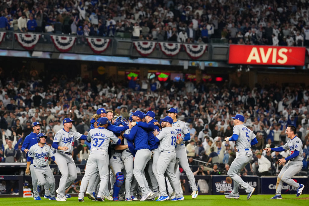 Members of the Los Angeles Dodgers celebrate on the field after the Dodgers defeated the New York Yankees in Game 5 to clinch the 2024 World Series.