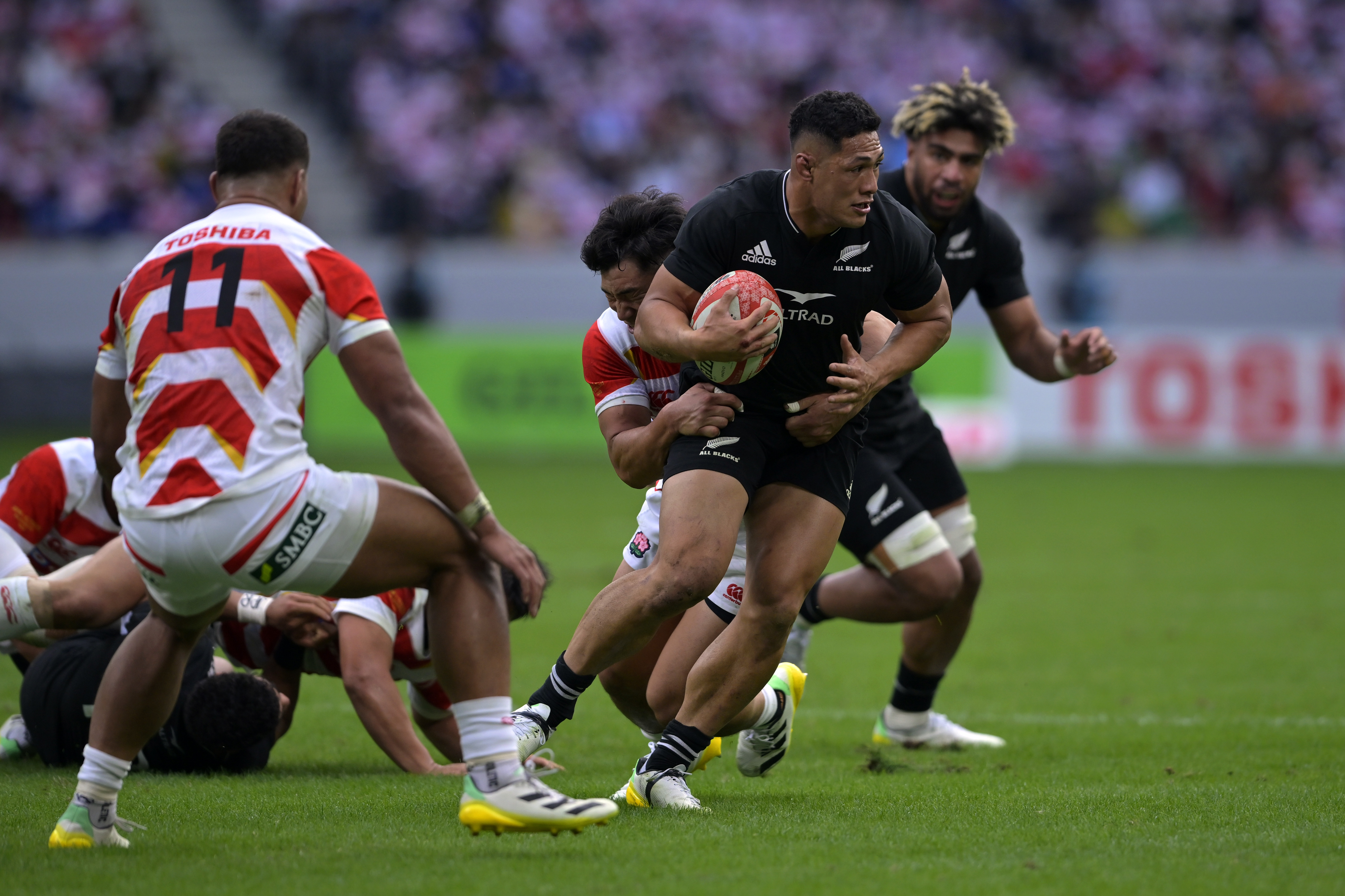 Roger Tuivasa-Sheck is tackled by Ryohei Yamanaka of Japan in their closely fought match at National Stadium in Tokyo.
