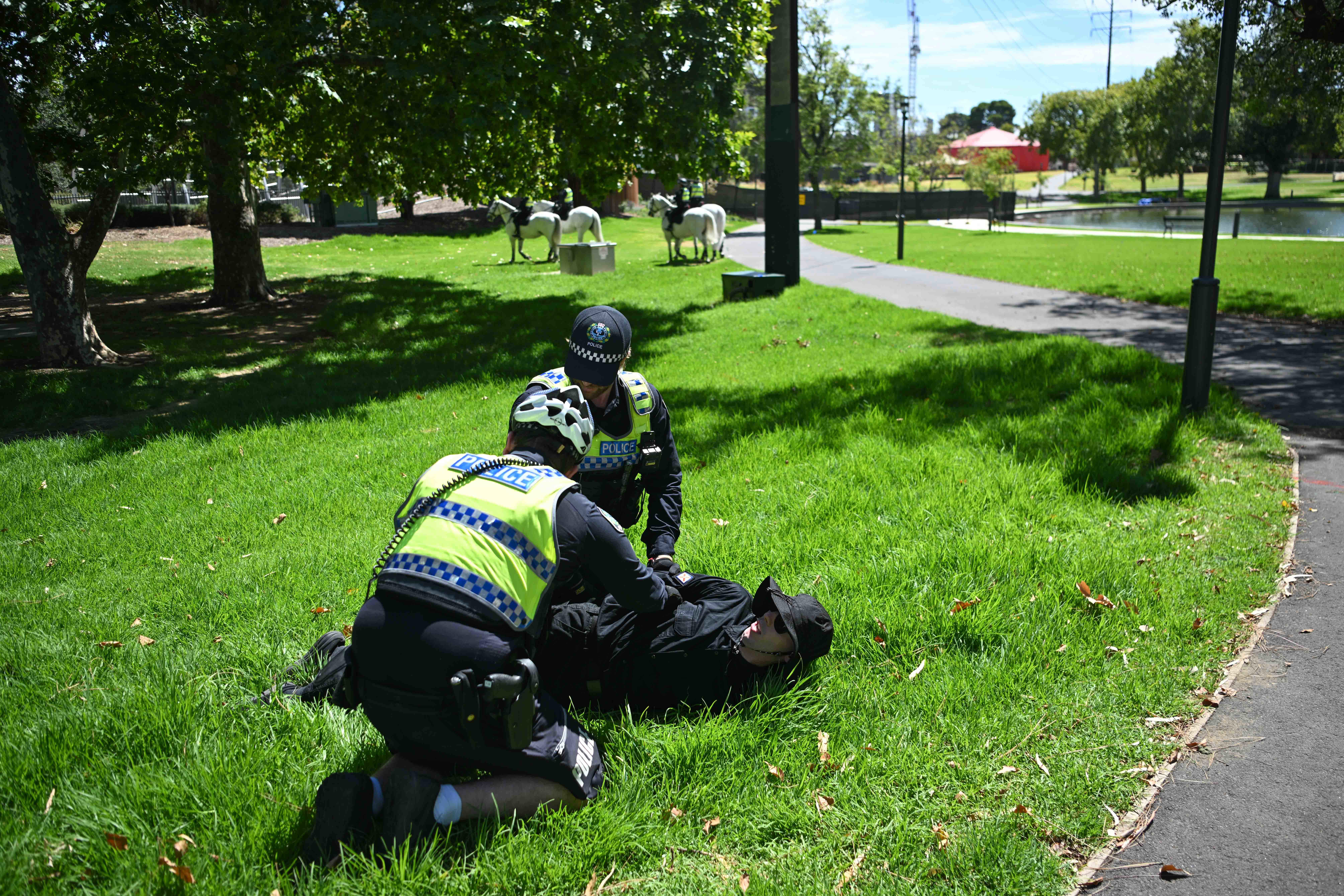 ADELAIDE, AUSTRALIA - JANUARY 26: Members of the National Socialist Network (NSN) are arrested as they hold in the East2 Parklands a counter protest on North Terrace on January 26, 2025 in Adelaide, Australia. Australia Day, formerly known as Foundation Day, is the official national day of Australia and is celebrated annually on January 26 to commemorate the arrival of the First Fleet to Sydney in 1788. Many indigenous Australians refer to the day as 'Invasion Day' and there is a small but growi