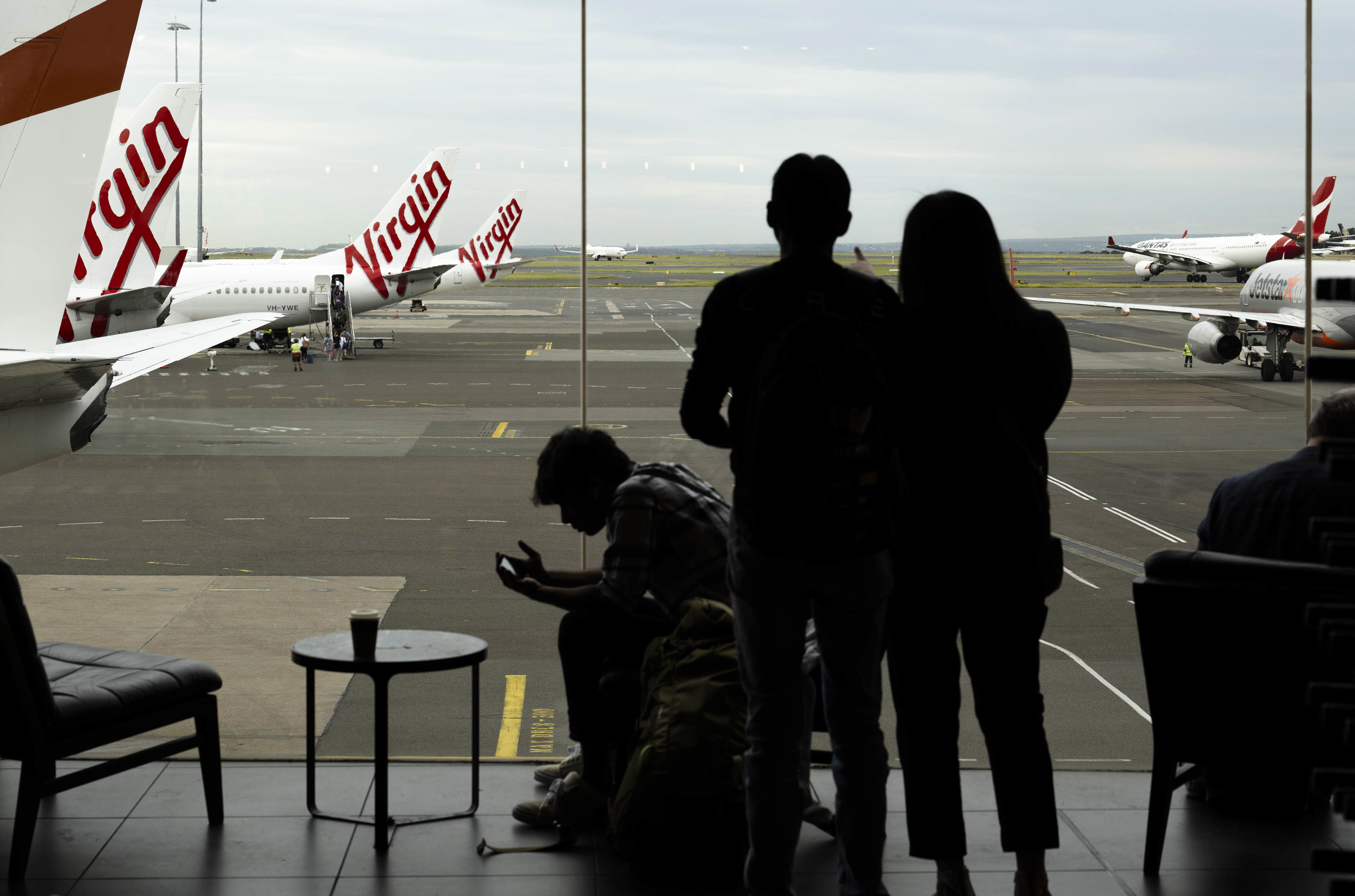 Passengers wait to catch their flights at Sydney's domestic airport