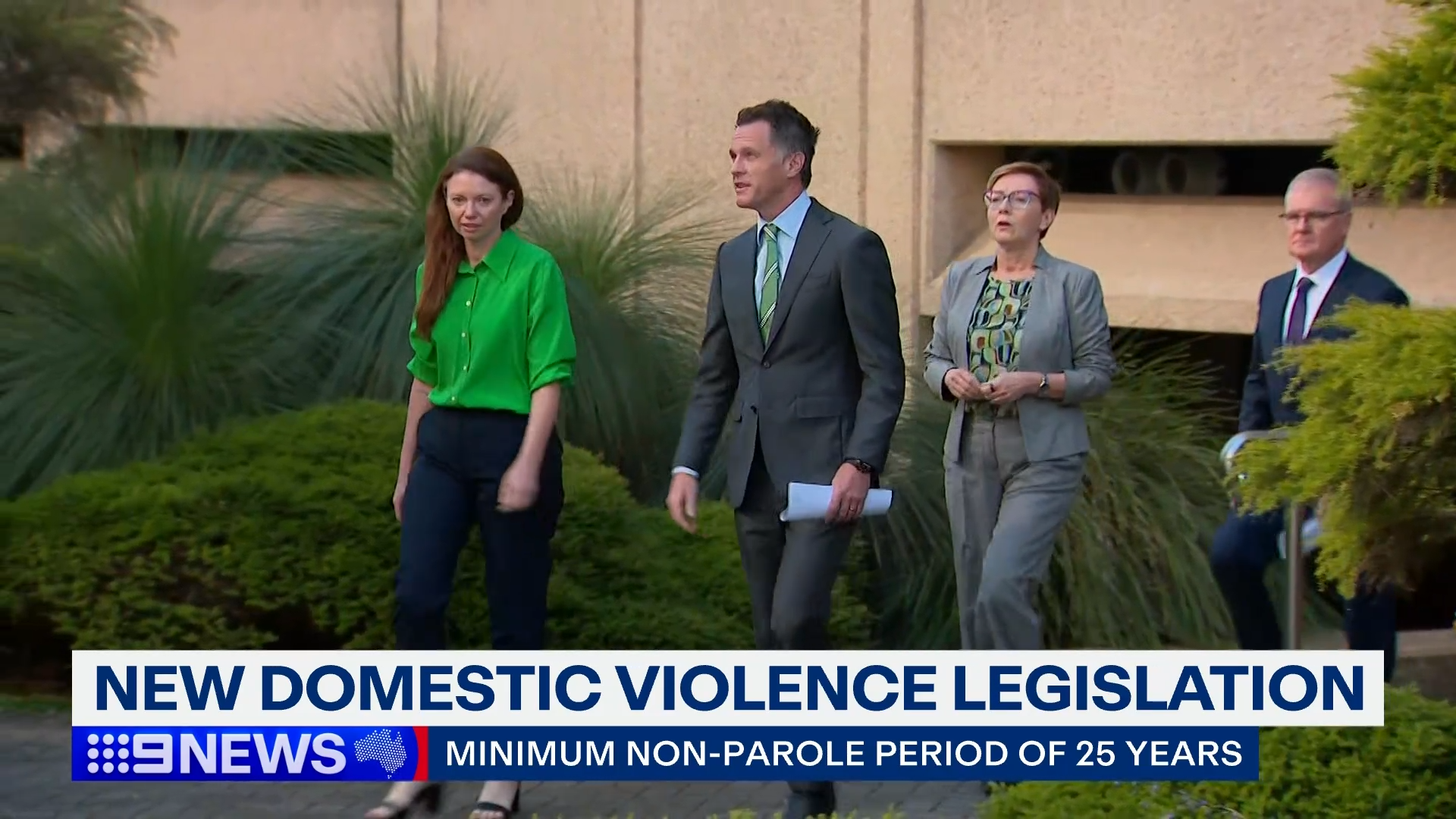 Chris Minns and Tabitha Acret walking on a footpath before announcing landmark domestic violence law reforms