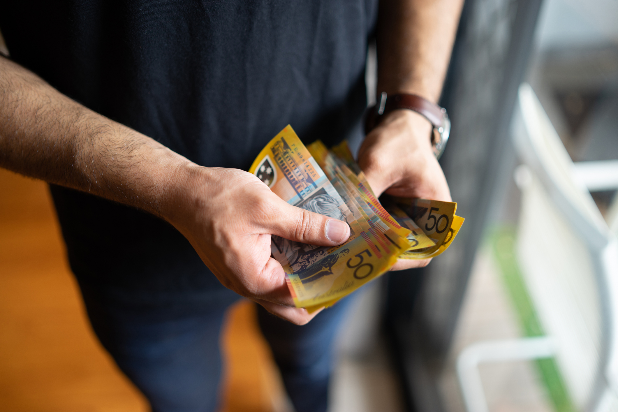 Cash stock image of cash person holding cash Australian money