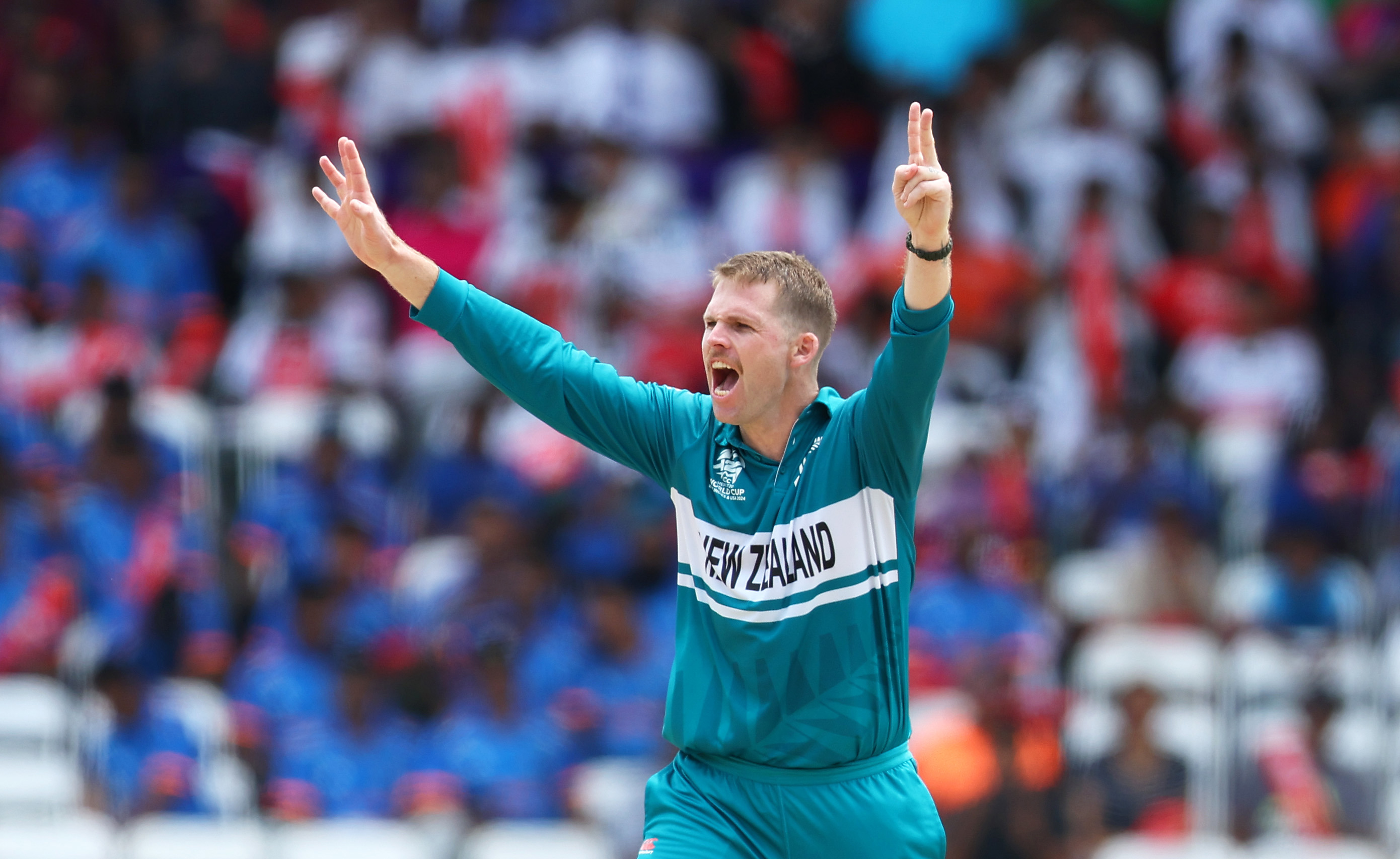 Lockie Ferguson of New Zealand celebrates the wicket of Charles Amini of Papua New Guinea.