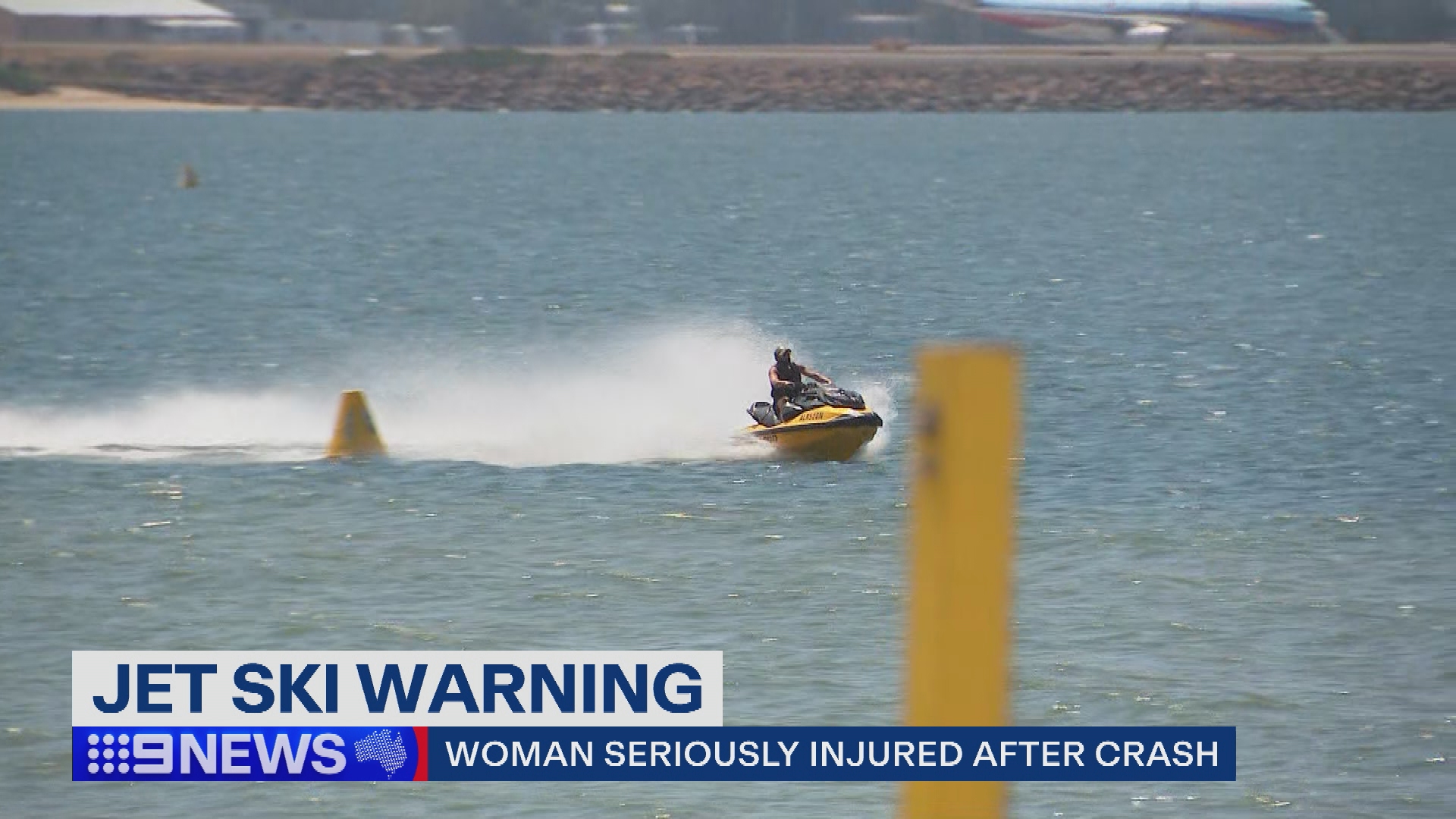 A person riding a yellow jet ski in the water.