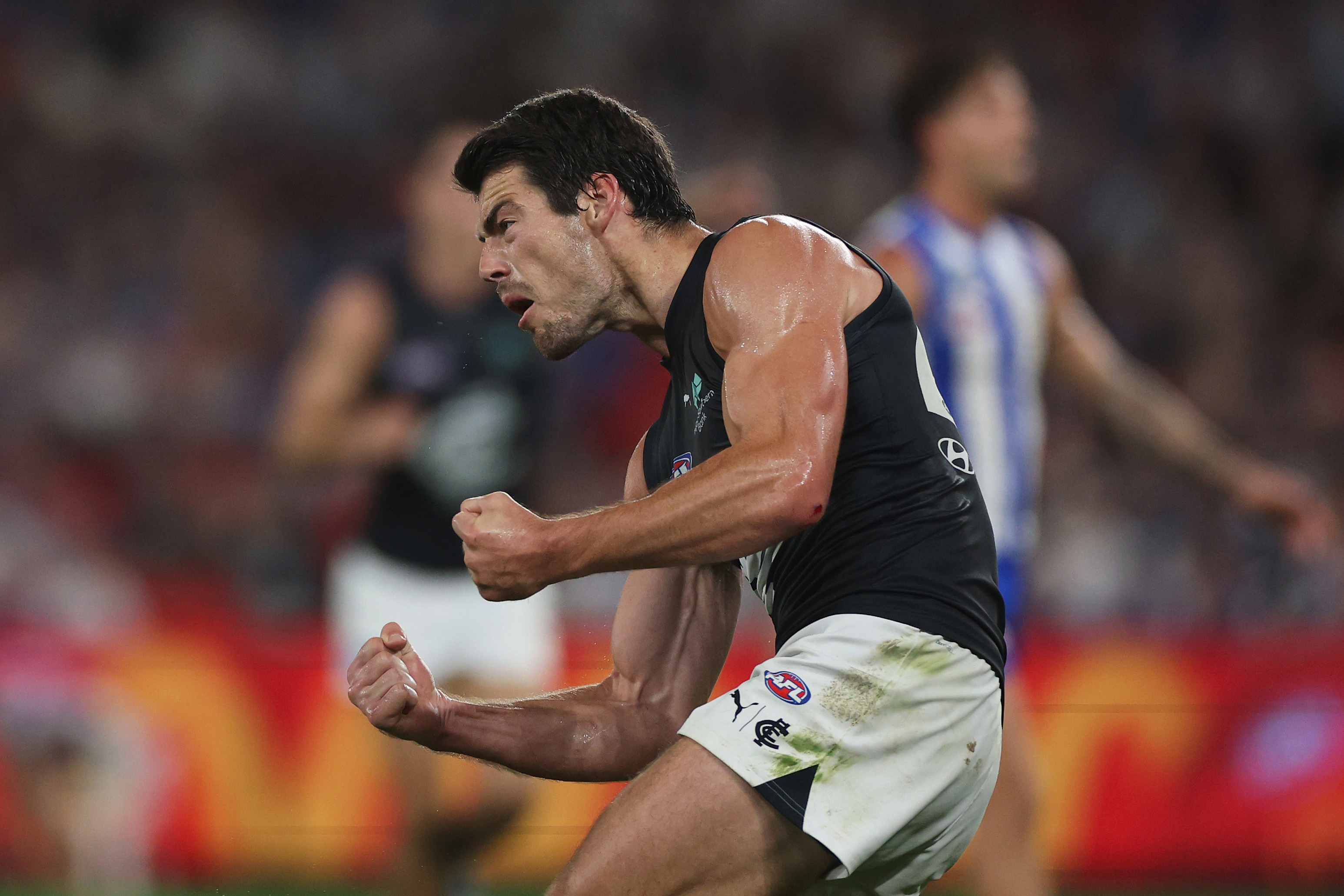 George Hewett of the Blues celebrates kicking a goal.