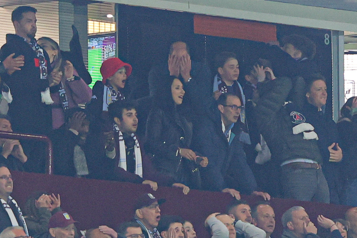 William, Prince of Wales, reacts after a missed chance with son George.