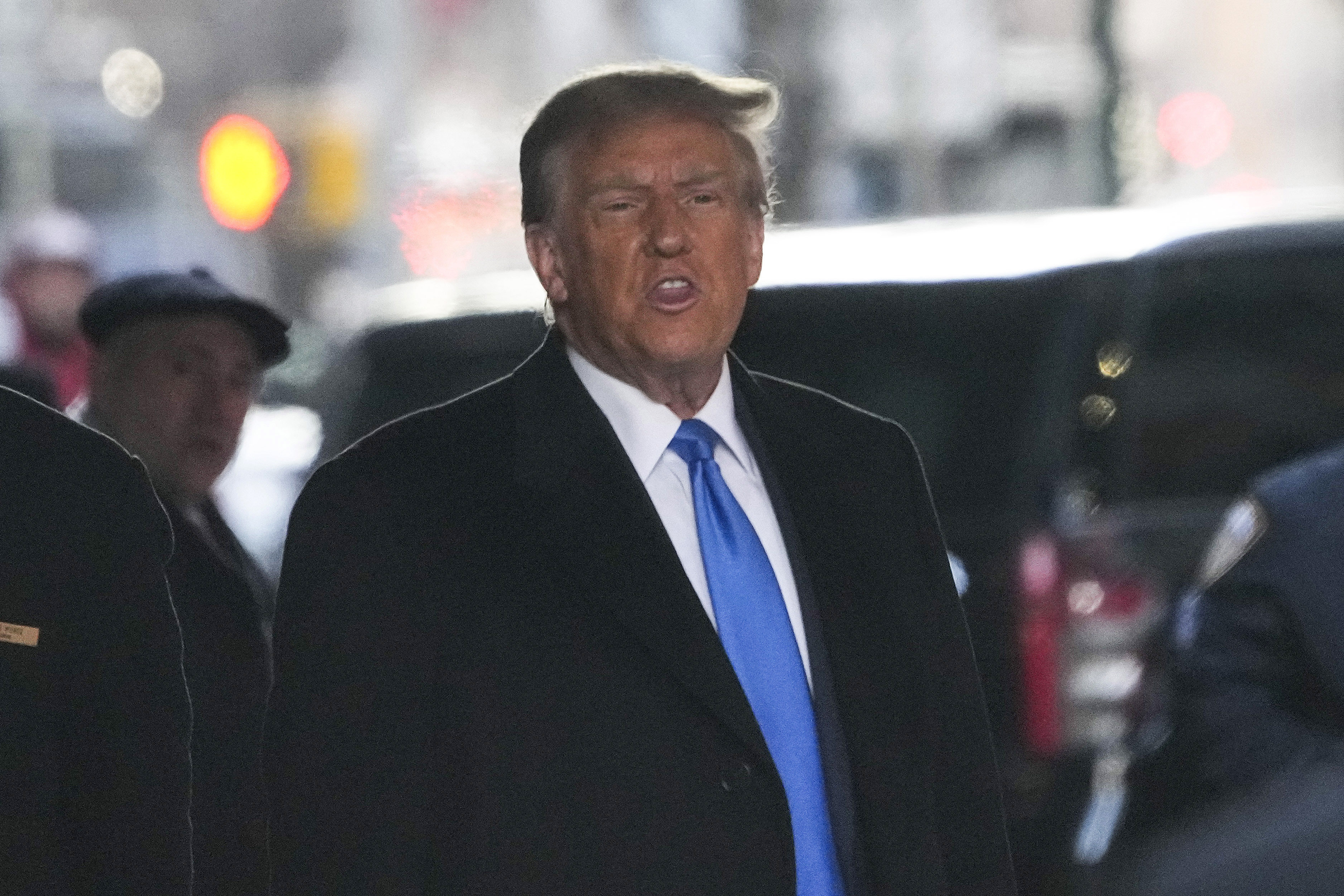 Former President Donald Trump leaves his apartment building in New York