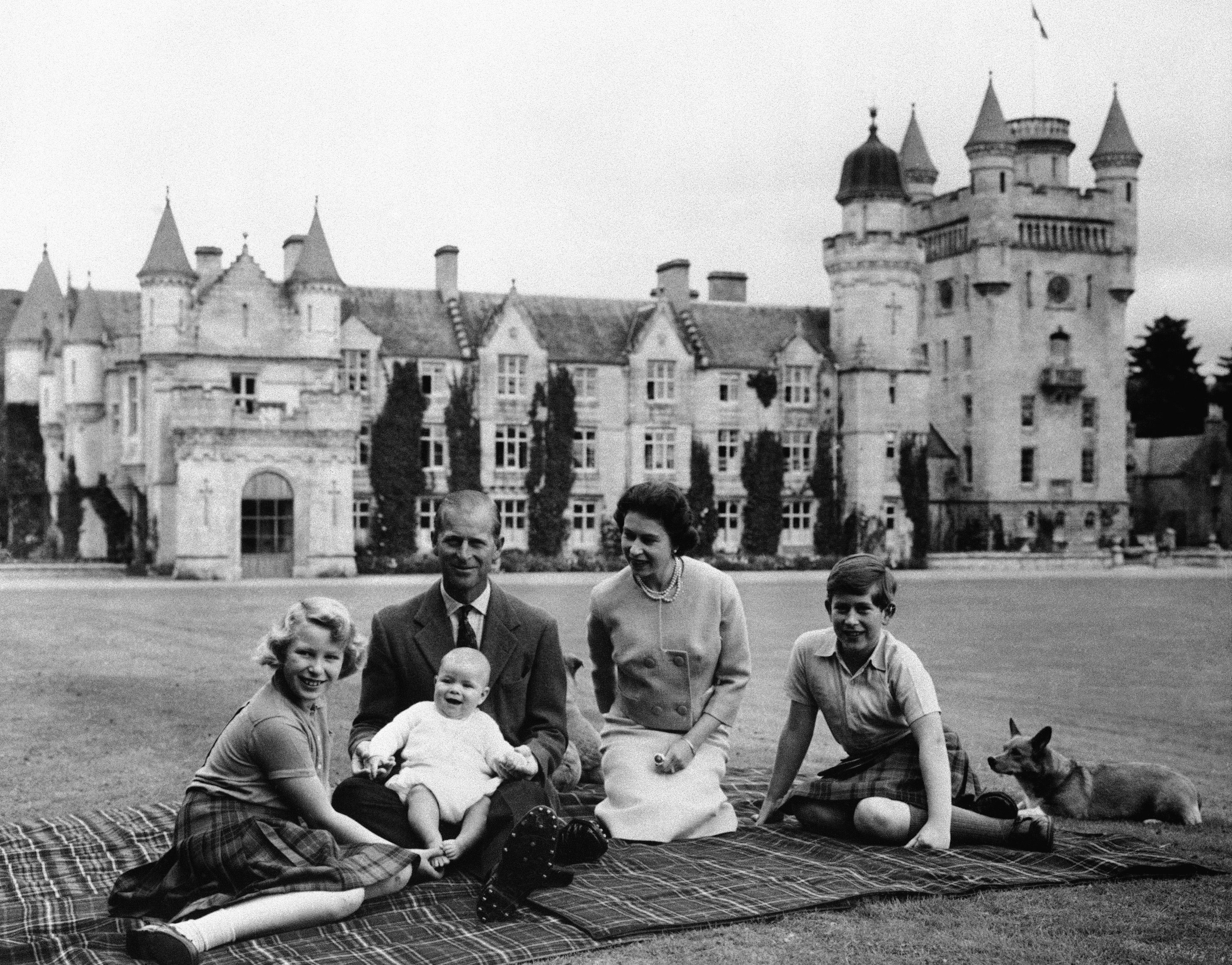 In this 1960 photo, Queen Elizabeth, Prince Philip and their children, Prince Charles, Princess Anne and Prince Andrew sit on the lawn of Balmoral Castle