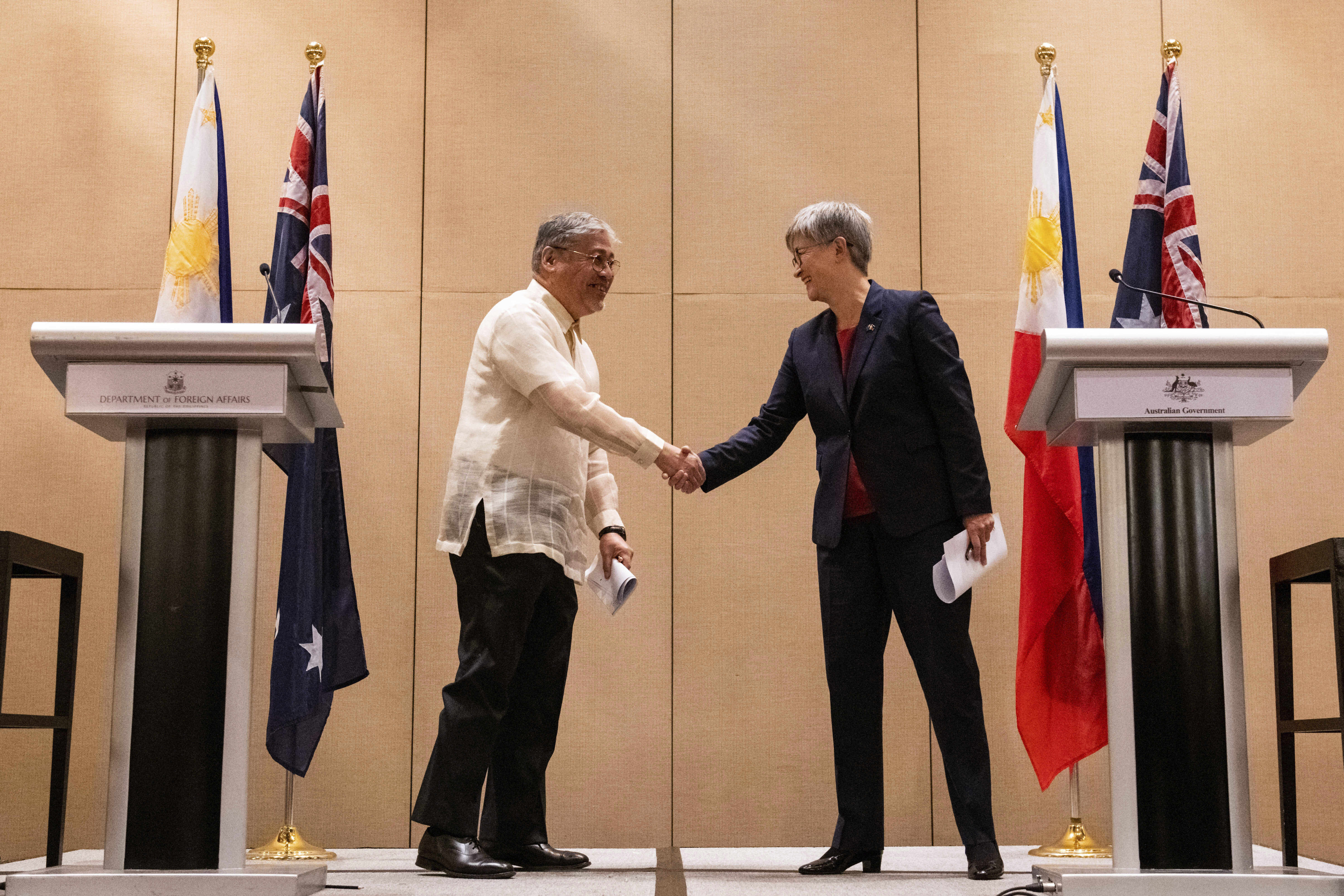 Australian Foreign Minister Penny Wong, right, and Philippine Foreign Affairs Secretary Enrique Manalo shake hands during a joint press conference at a hotel in Makati City, Philippines on Thursday May 18, 2023.