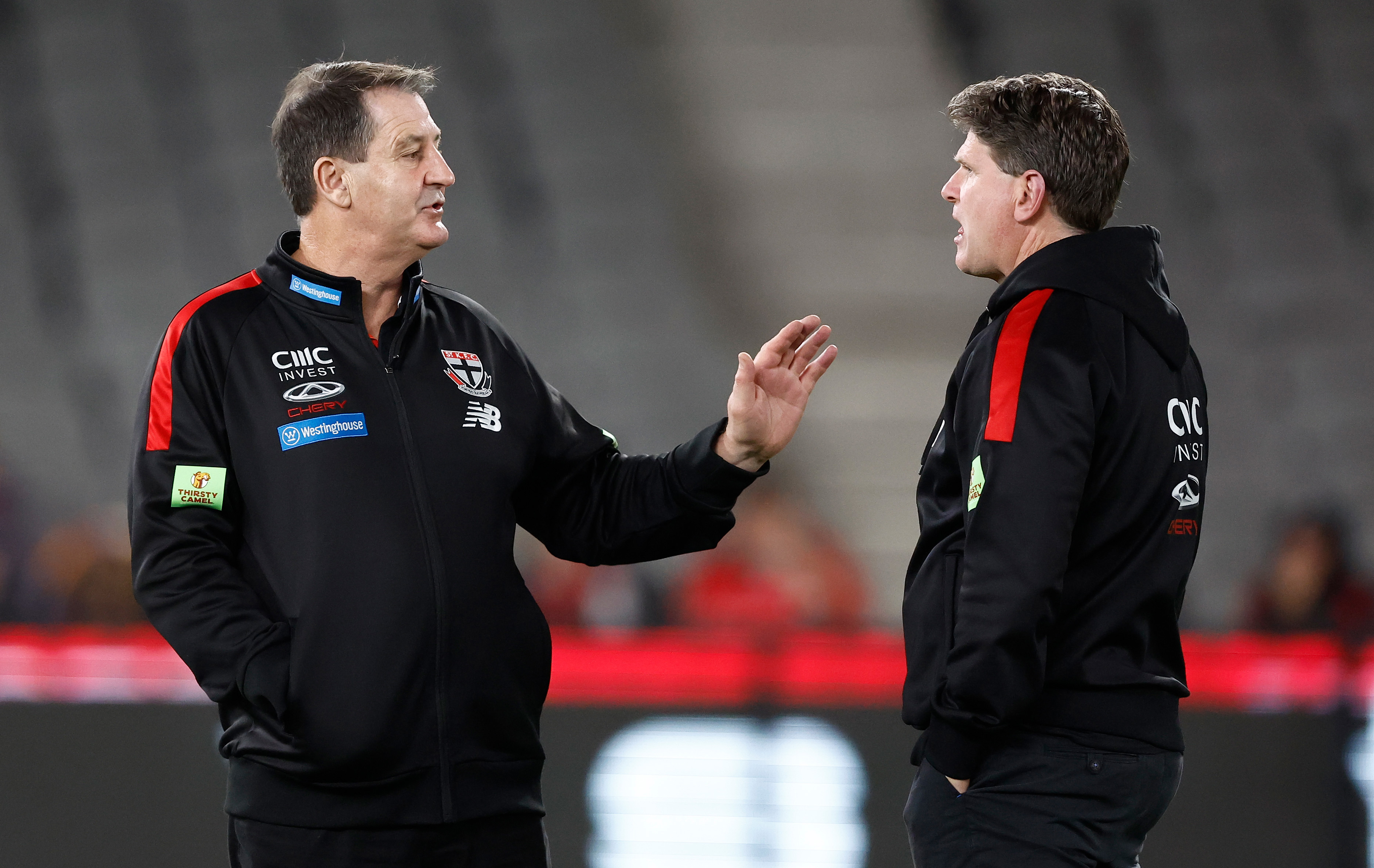 Ross Lyon, Senior Coach of the Saints speaks with assistant coach Robert Harvey.