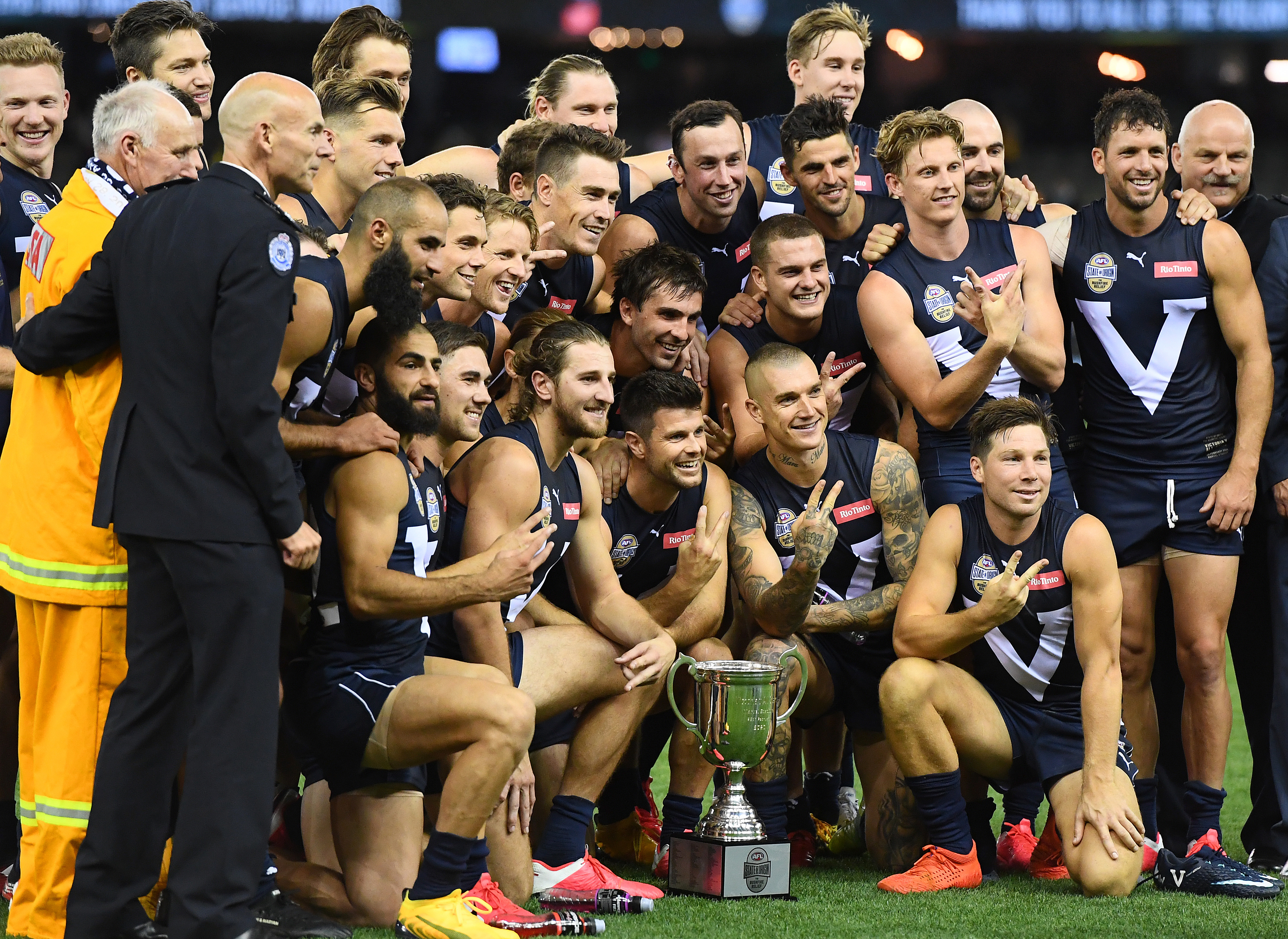 The Victorian players pose with the trophy after winning the AFL Bushfire Relief State of Origin match in 2020.