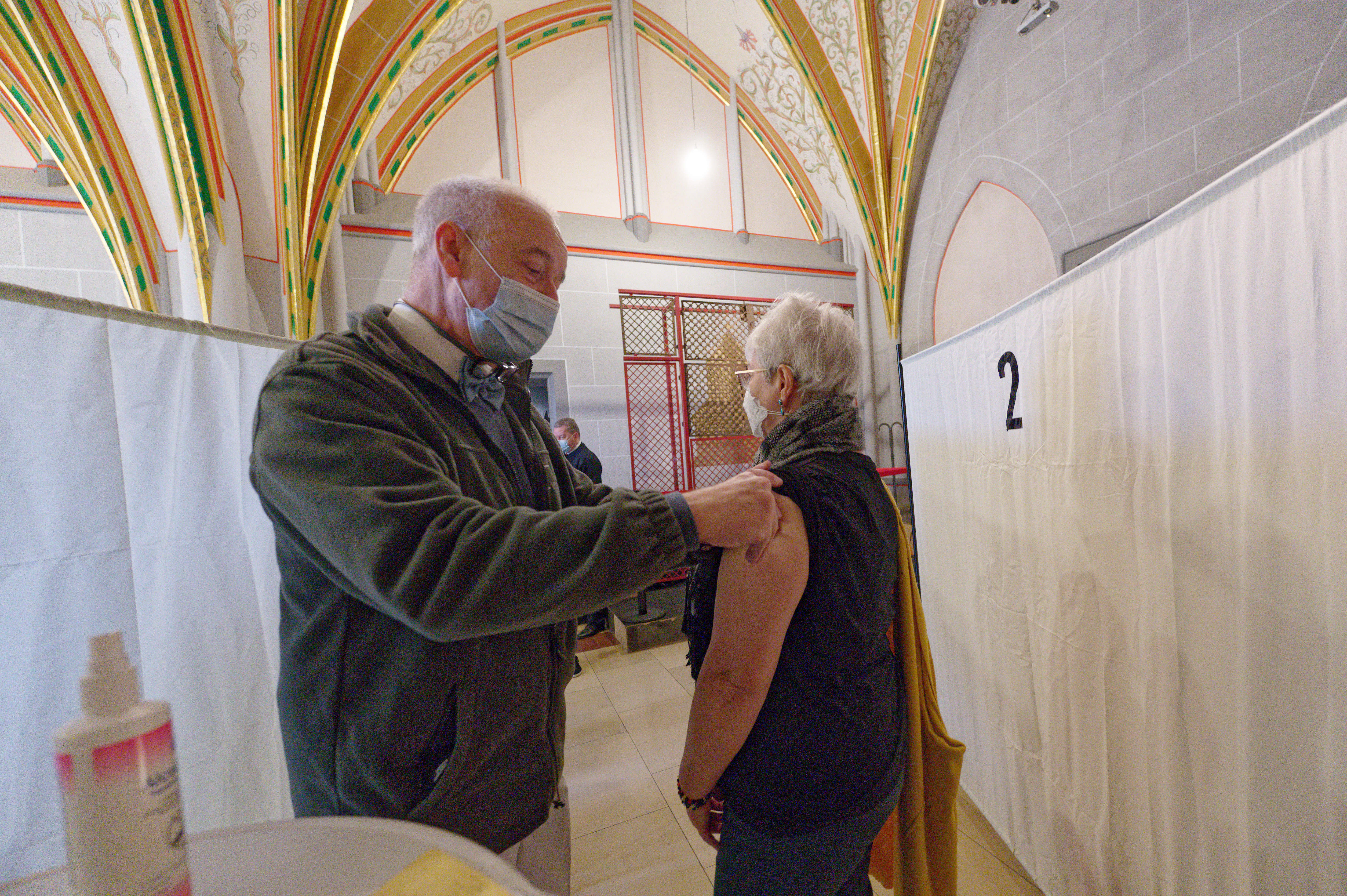 A woman receives a vaccination during a Christmas vaccination campaign in the Dreikönigensaal of Cologne Cathedral. 24 December 2021, North Rhine-Westphalia, Cologne