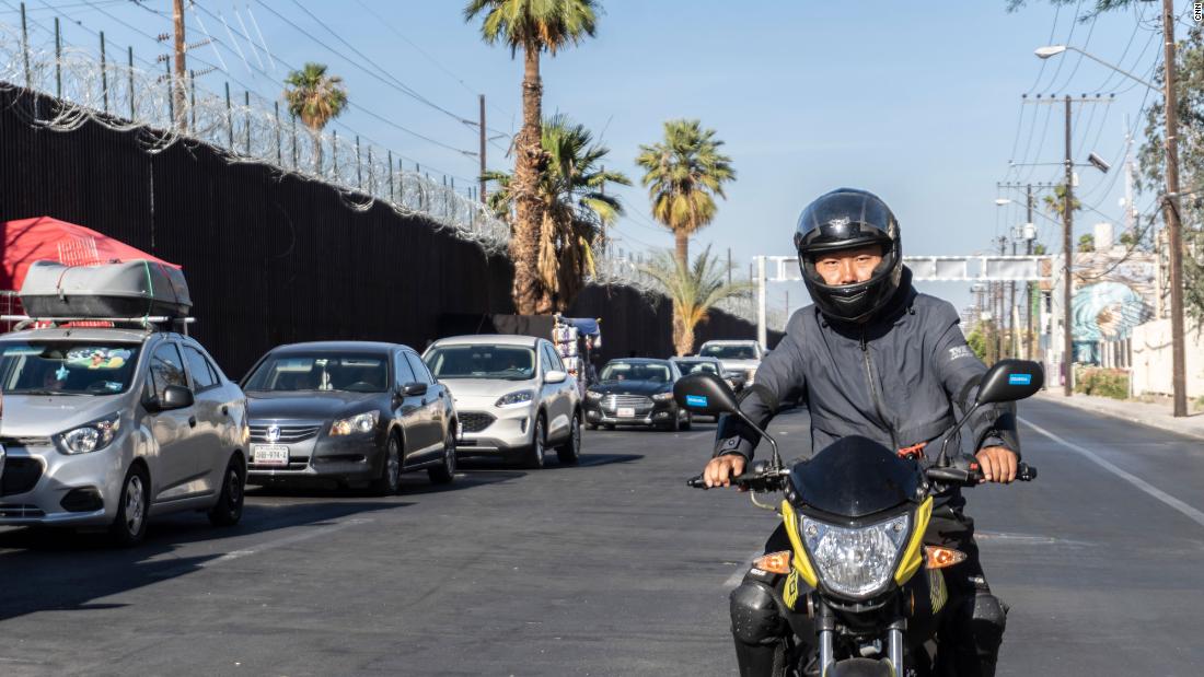 Wang Qun drives his motorcycle in Mexicali.