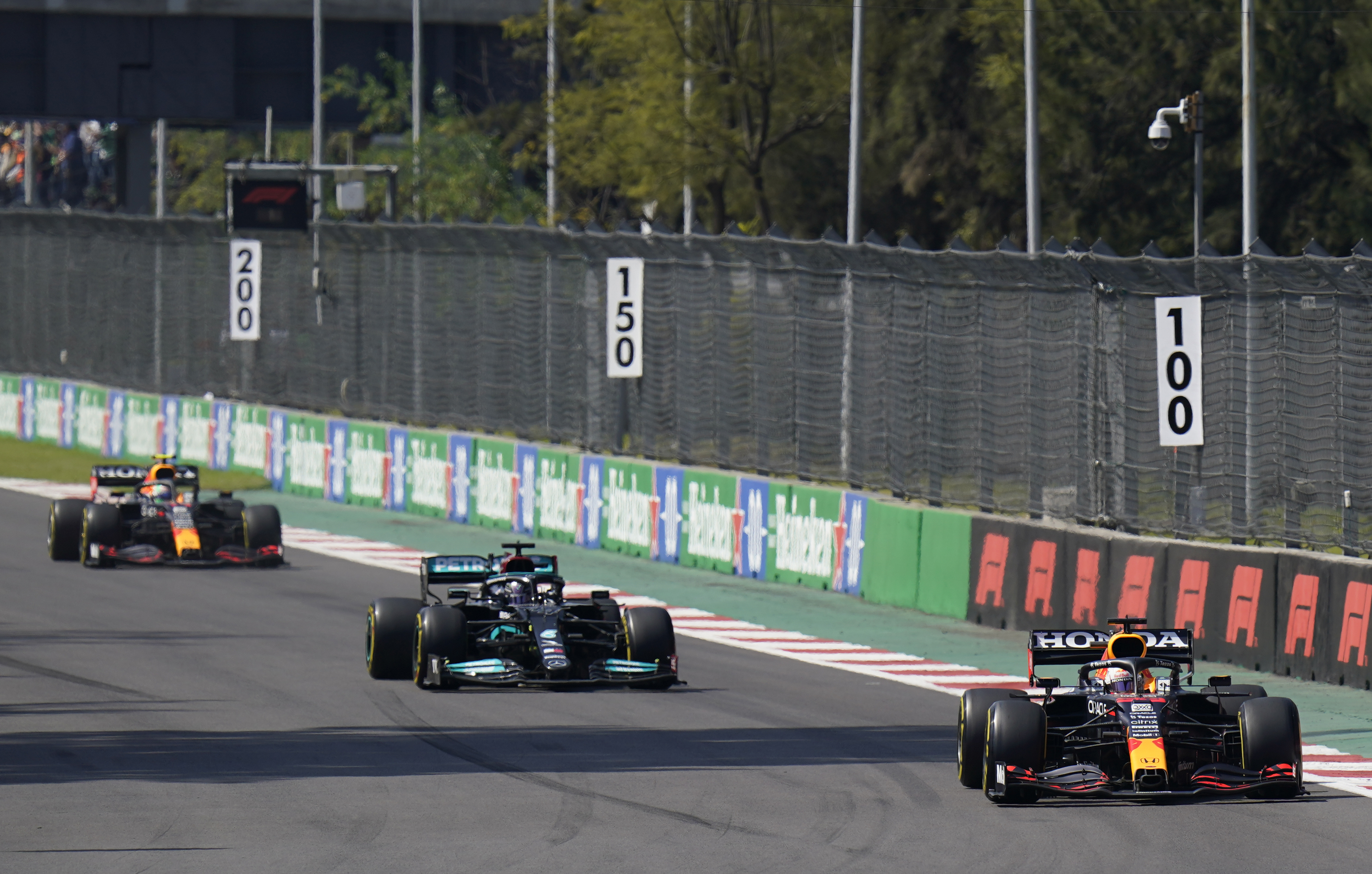 Red Bull driver Max Verstappen, of The Netherlands, leads the race, with Mercedes driver Lewis Hamilton, of Britain, during the Formula One Mexico Grand Prix.