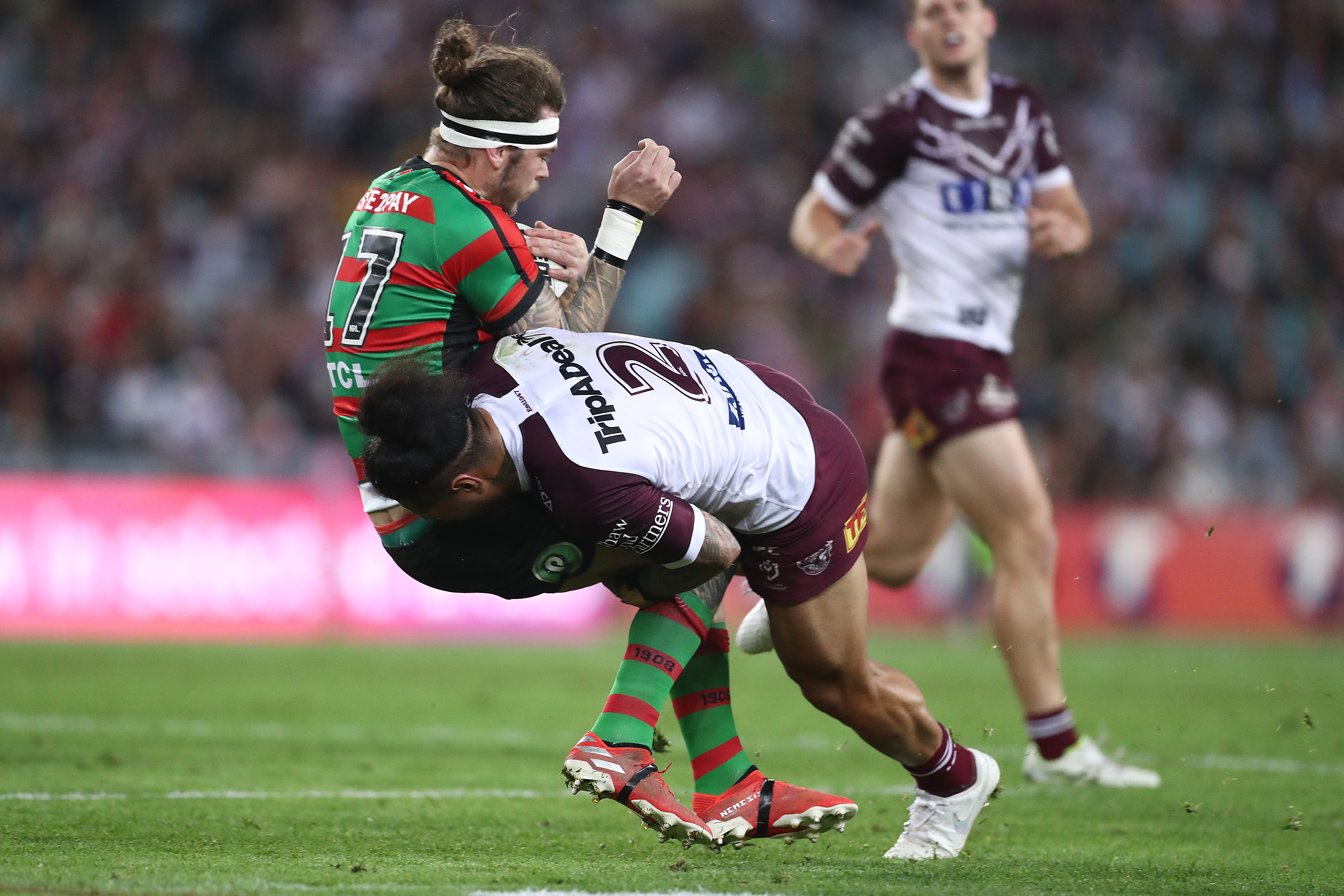 Jorge Taufua of the Sea Eagles tackles Ethan Lowe of the Rabbitohs.