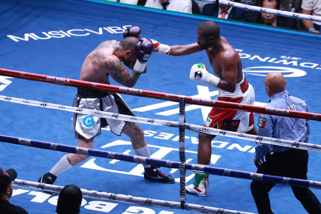 Floyd Mayweather Jr. (R) and John Gotti III exchange punches during their exhibition fight.