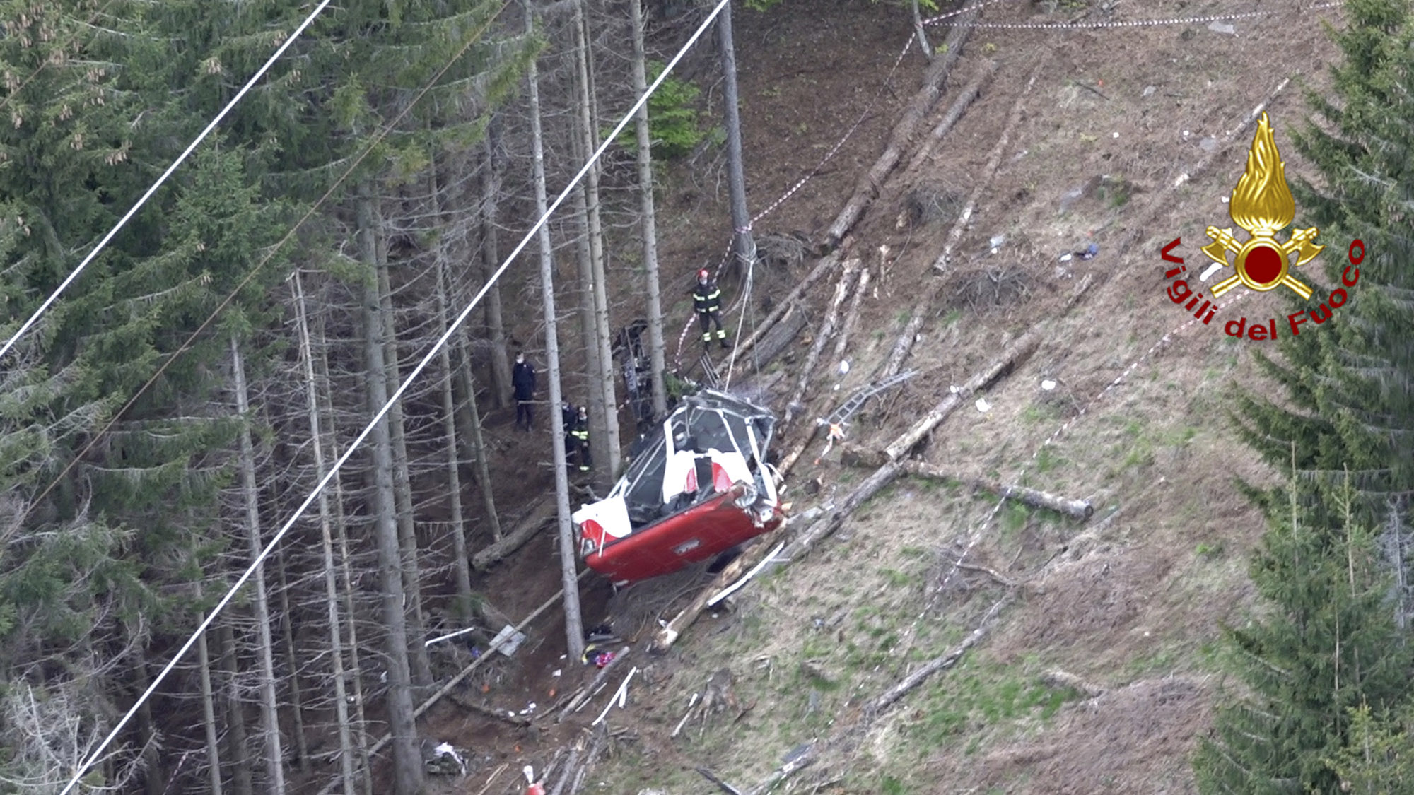 Rescuers worked by the wreckage of a cable car after it collapsed near the summit of the Stresa-Mottarone line in the Piedmont region, northern Italy. 