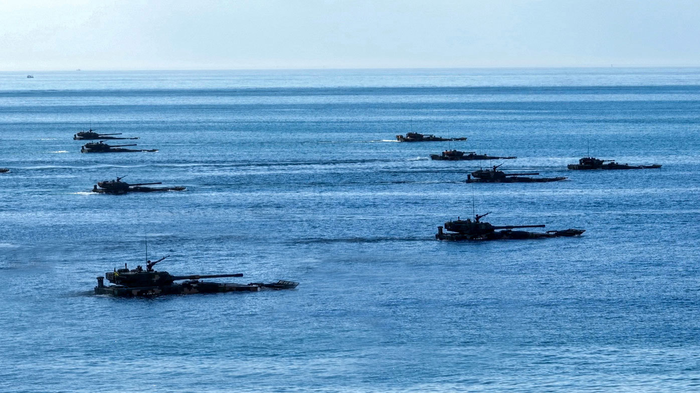 Chinese tanks move out of the water.