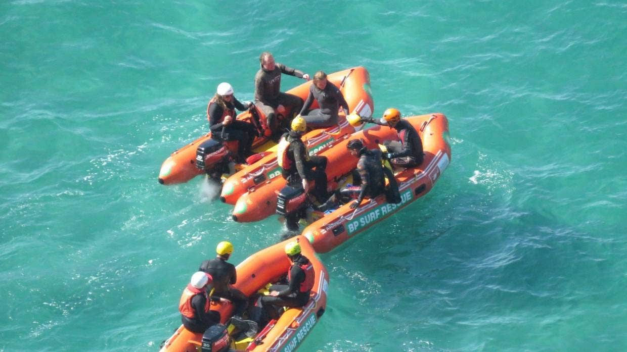 Rescuers search an area near Dunedin's Second Beach.