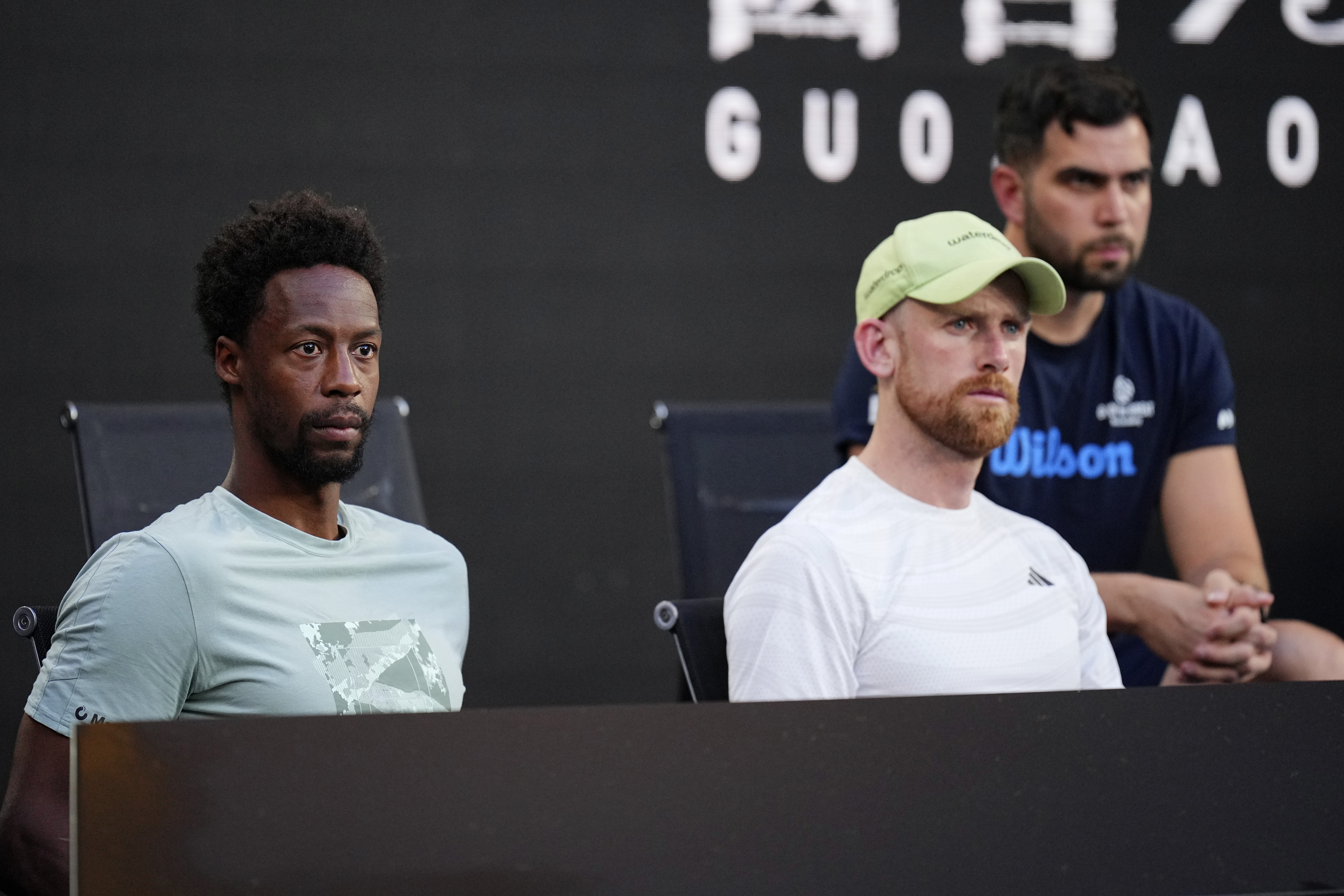 Gael Monfils, left, watches his wife, Elina Svitolina of Ukraine, from the coaches box, play Jasmine Paolini of Italy in their third round match at the Australian Open tennis championship in Melbourne, Australia, Saturday, Jan. 18, 2025. (AP Photo/Vincent Thian)