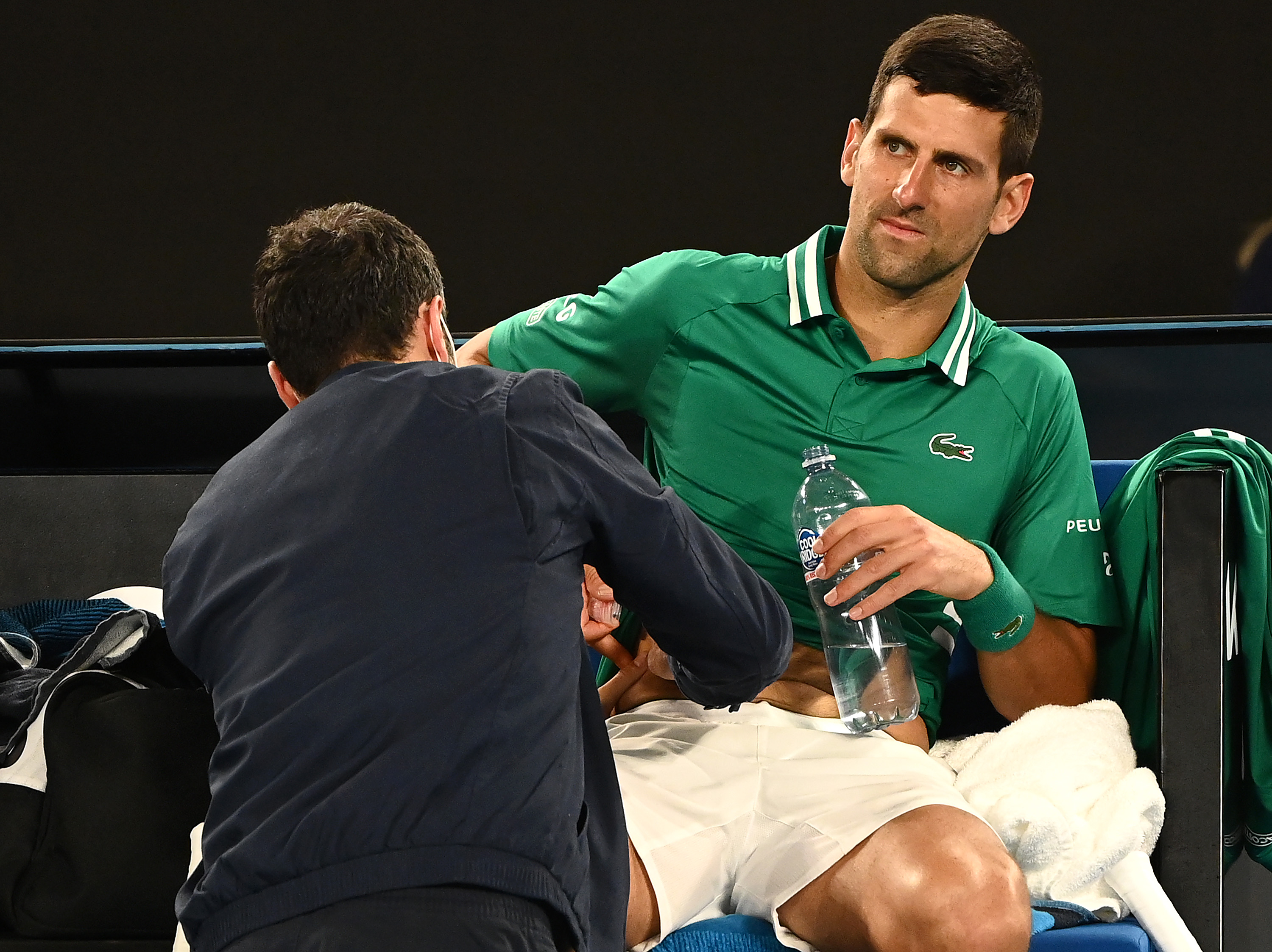 MELBOURNE, AUSTRALIA - FEBRUARY 12: Novak Djokovic of Serbia received medical treatment in his Men's Singles third round match against Taylor Fritz of the United Statesduring day five of the 2021 Australian Open at Melbourne Park on February 12, 2021 in Melbourne, Australia. (Photo by Quinn Rooney/Getty Images)
