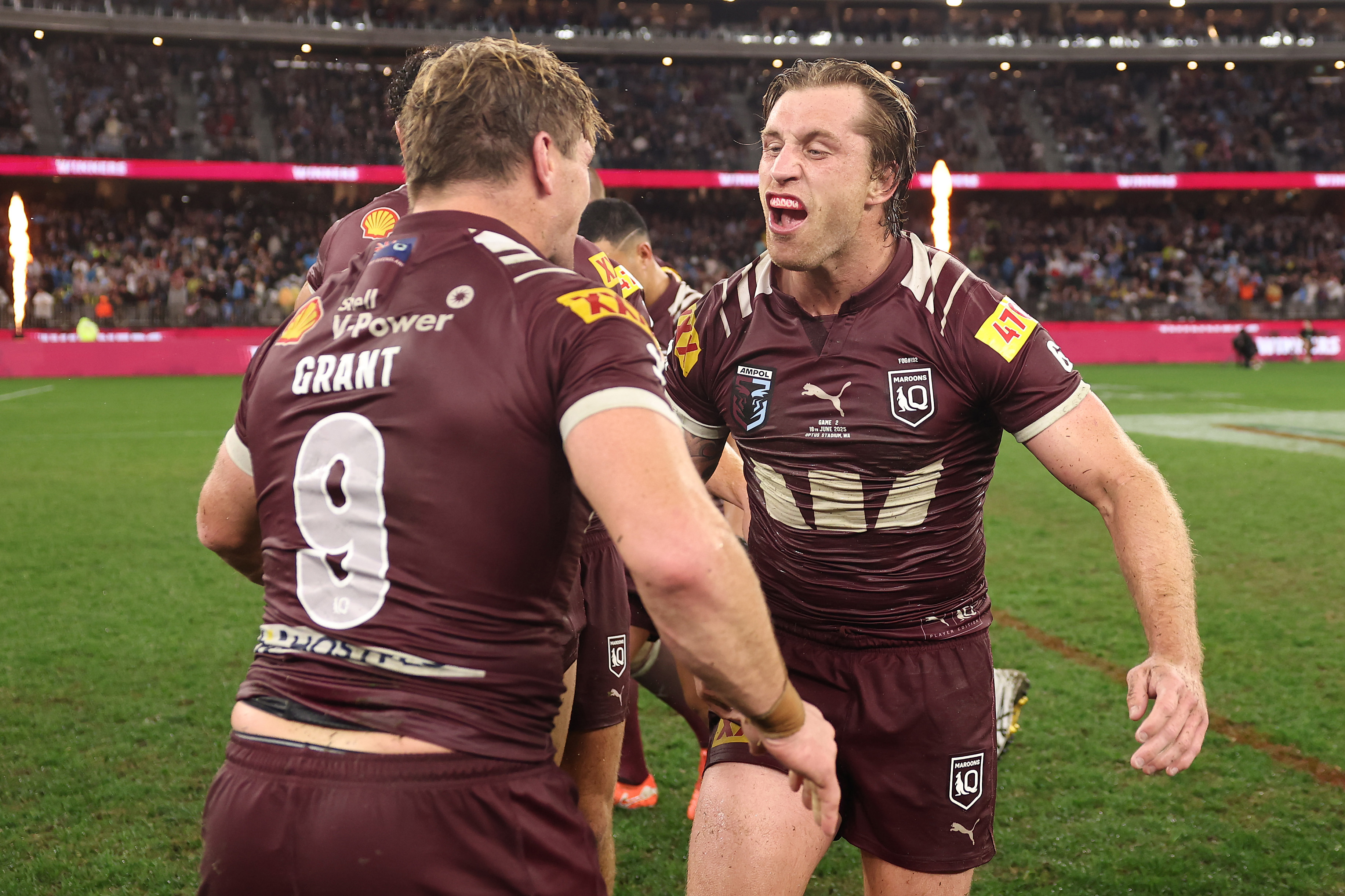Cameron Munster and Harry Grant celebrate Queensland's win in game two of the 2025 State of Origin series.