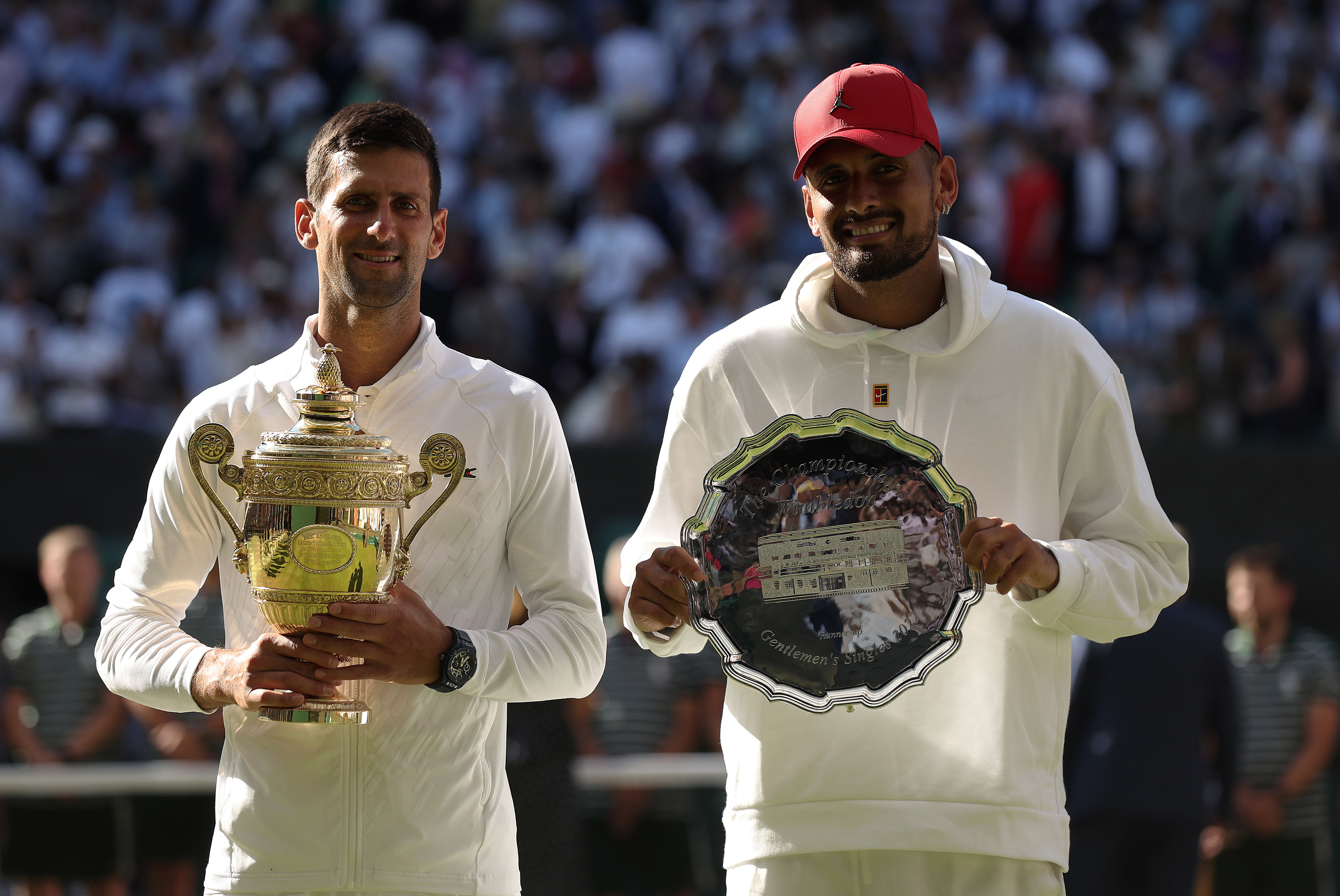 Novak Djokovic and Nick Kyrgios pose with their trophies after the 2022 Wimbledon final.