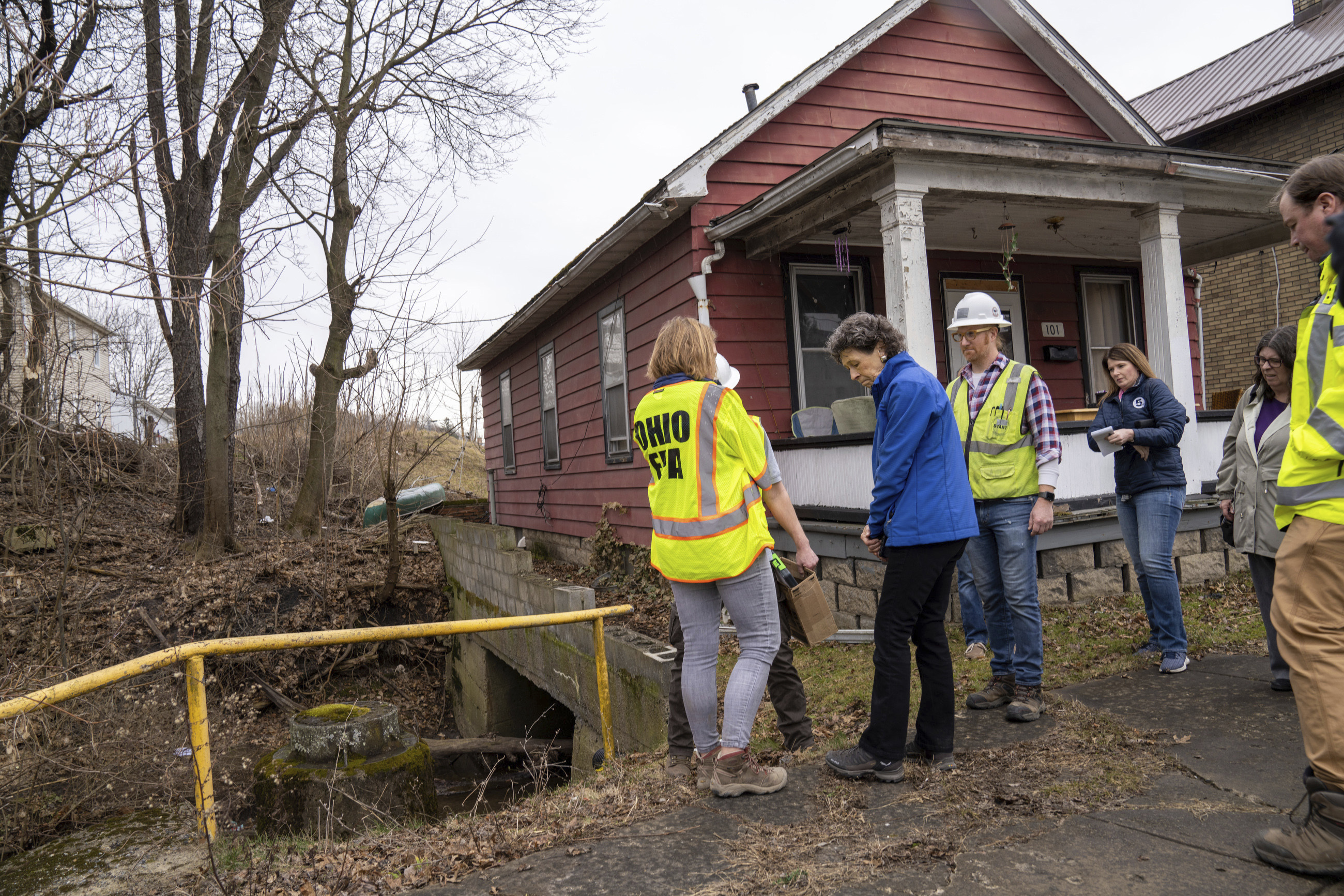 Ohio EPA officials, including director Anne Vogel, left, took a tour of the damage in East Palestine, Ohio on Thursday, Feb. 16, 2023. Residents of the Ohio village upended by a freight train derailment are demanding to know if they're safe from the toxic chemicals that spilled or were burned off to avoid an even bigger disaster. (Lucy Schaly/Pittsburgh Post-Gazette via AP)