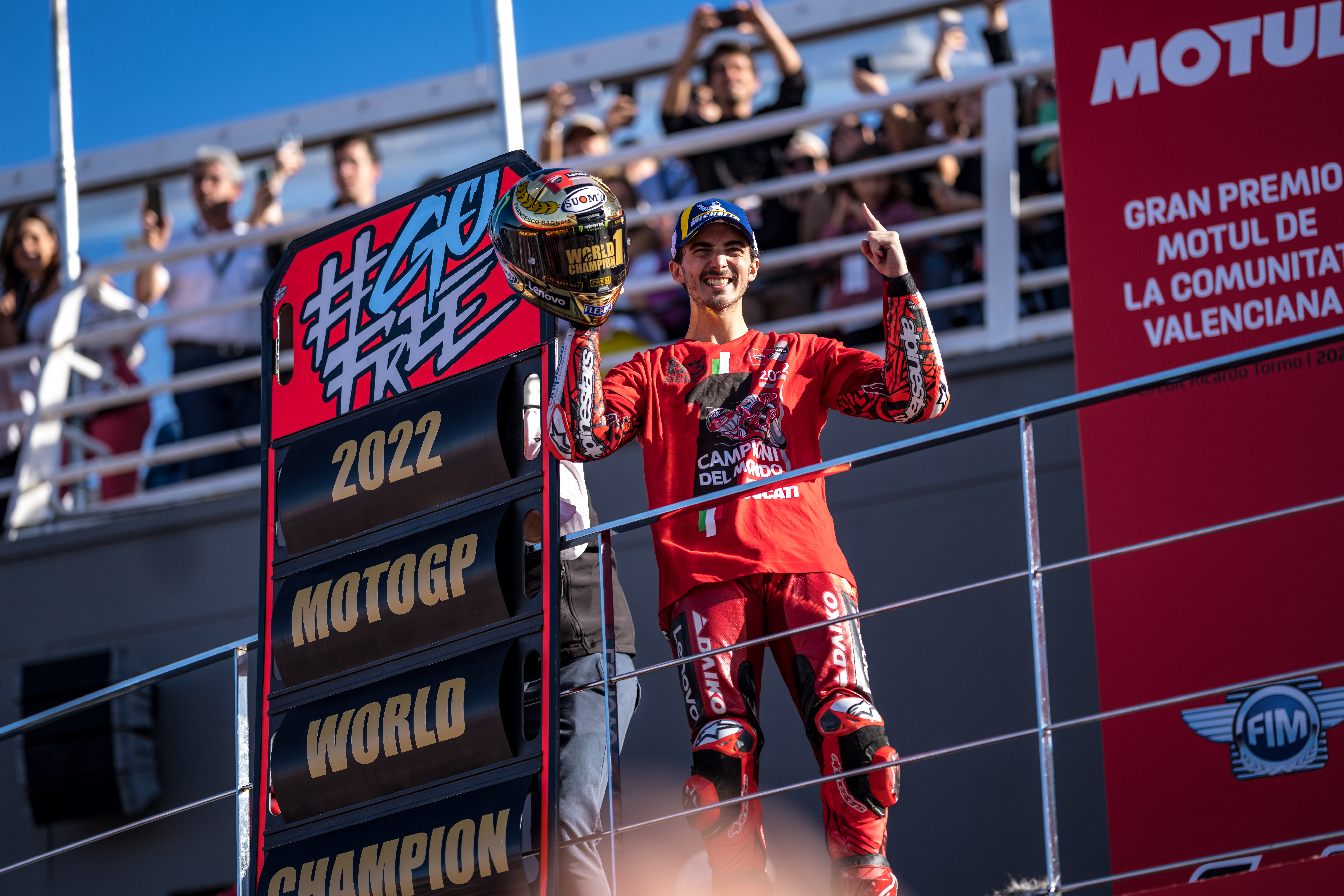 New world champion Francesco Bagnaia celebrates on the podium.