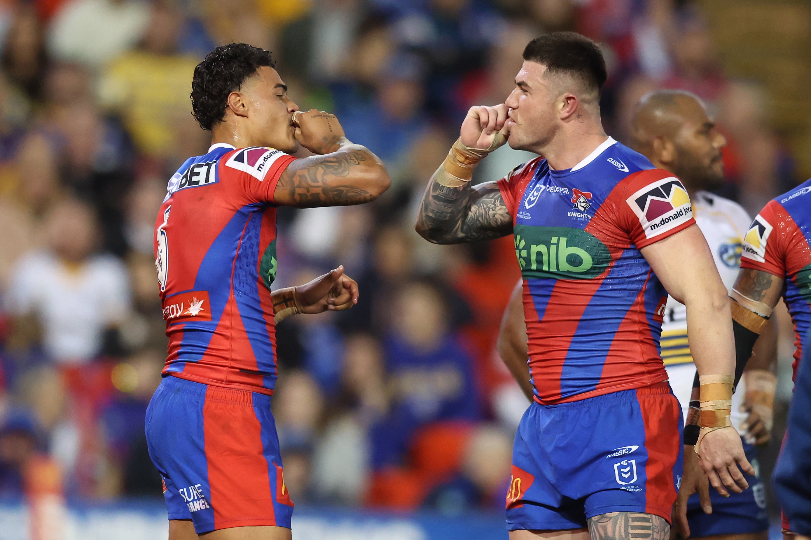 Will Pryce celebrates scoring his maiden NRL try with Knights' teammate Bradman Best.