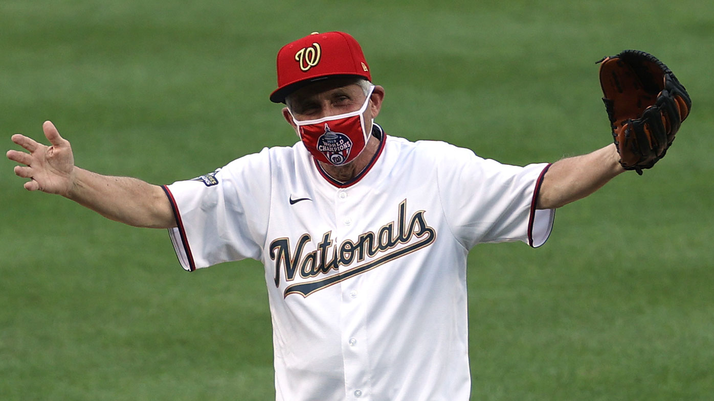Dr. Anthony Fauci, director of the National Institute of Allergy and Infectious Diseases reacts after throwing out the ceremonial first pitch