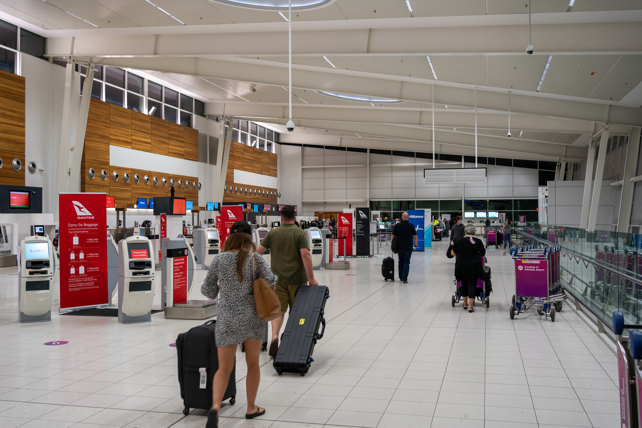 Adelaide, Australia - 1 Feb 2021: A few people in Adelaide airport walking to the check-in counter. South Australia is currently in the 'very low-risk' category and so South Australian can travel interstate freely.