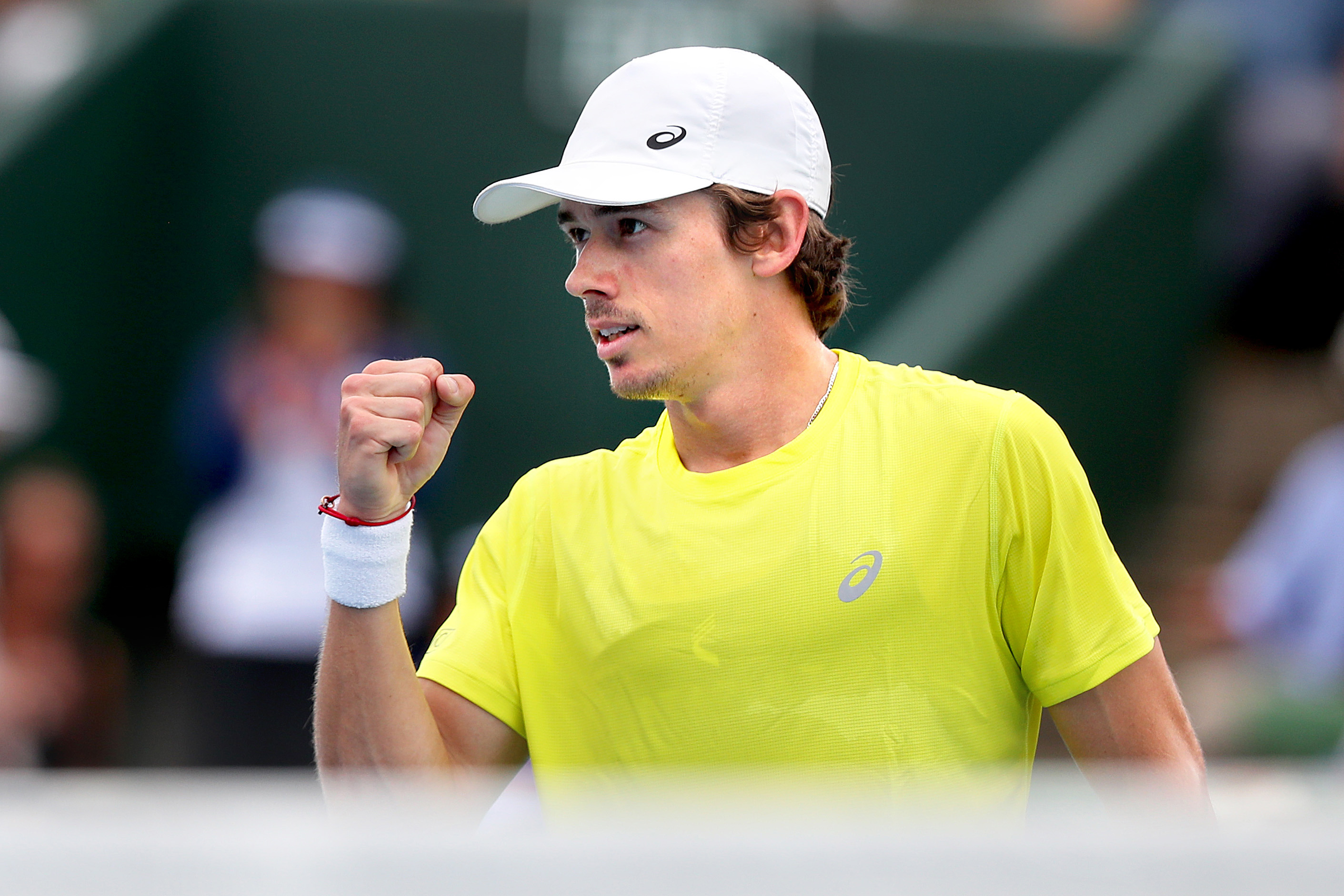 Alex de Minaur of Australia celebrates after winning the first set.