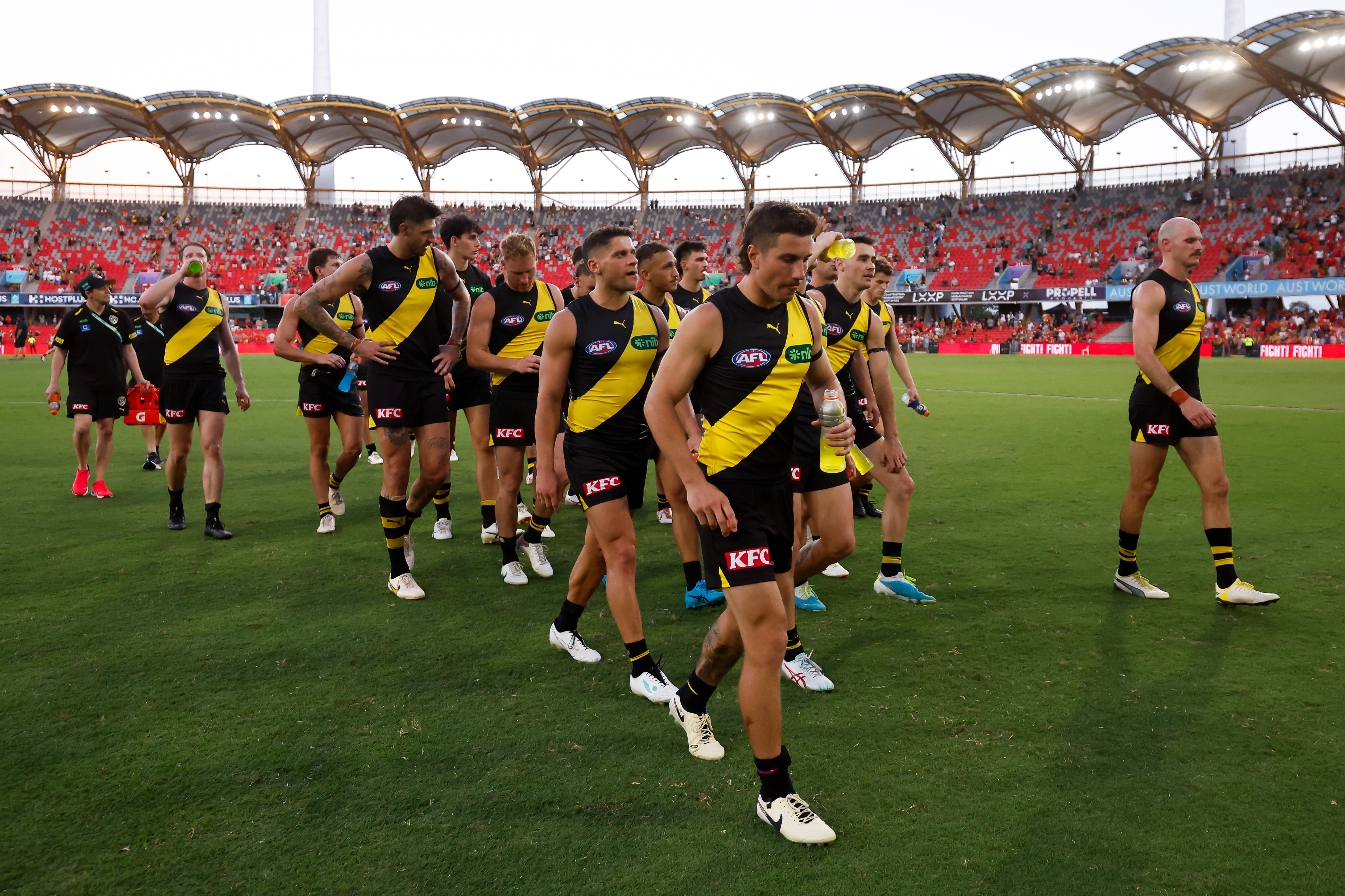 The Tigers leave the field after a loss during the 2024 AFL Opening Round match between the Gold Coast SUNS and the Richmond Tigers at People First Stadium on March 09, 2024 in Gold Coast, Australia. (Photo by Dylan Burns/AFL Photos via Getty Images)