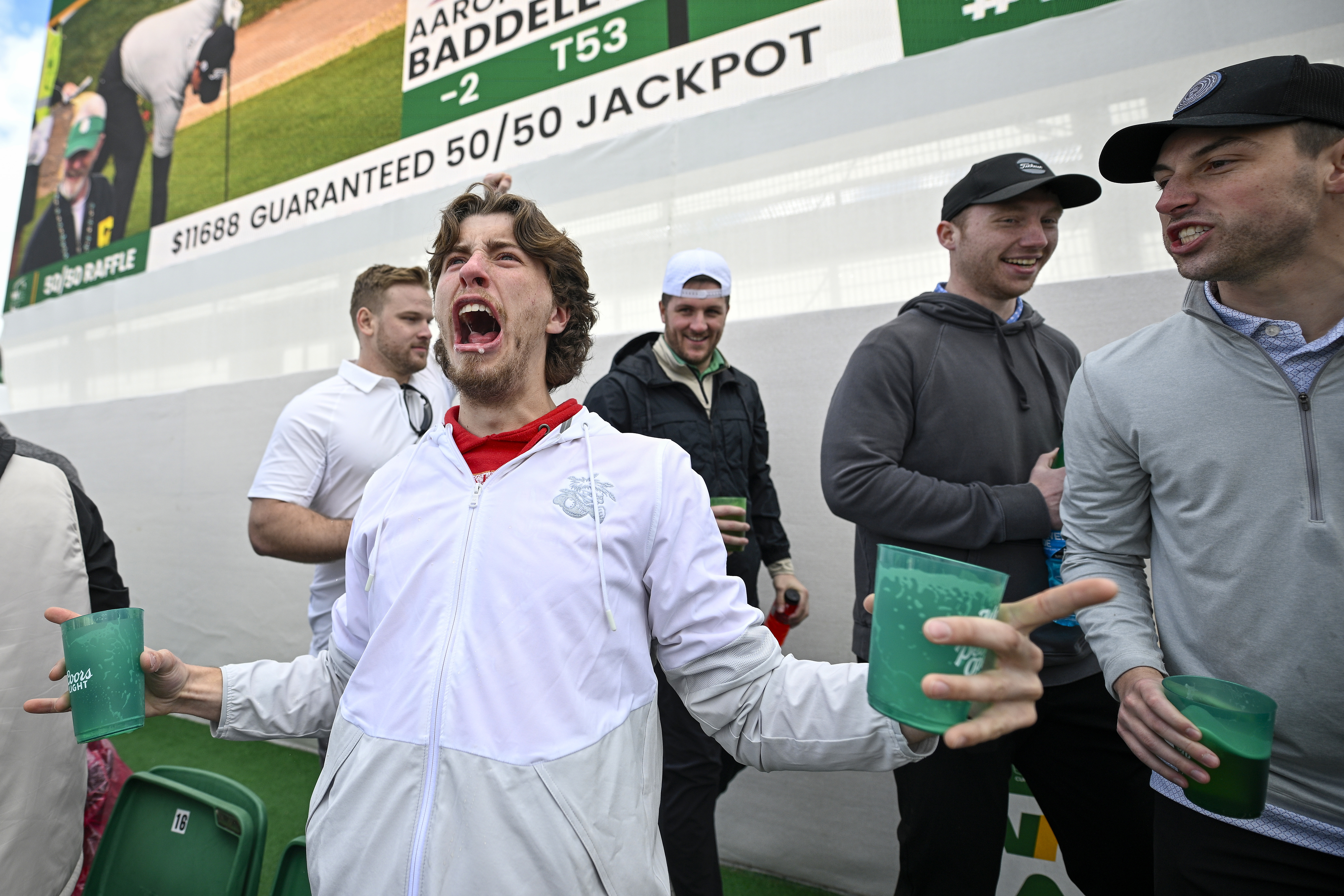 Fans celebrate on the 16th green.