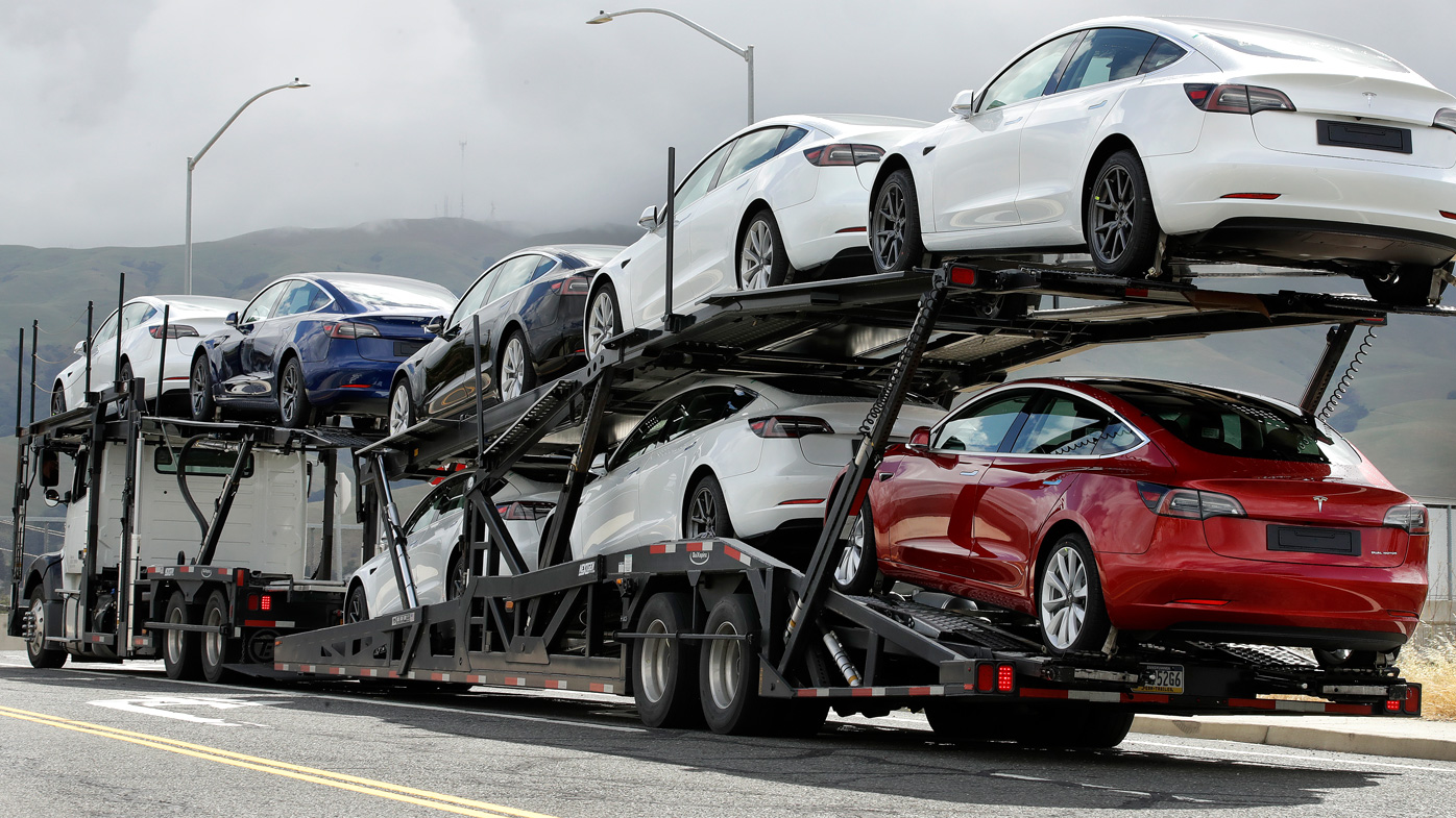 A truck loaded with Tesla cars departs the Tesla plant in Fremont, California.