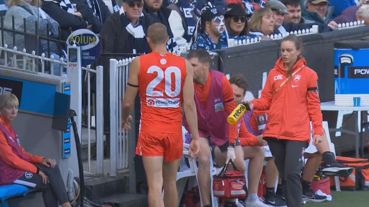 Swans forward Sam Reid leaves the field injured during the grand final.