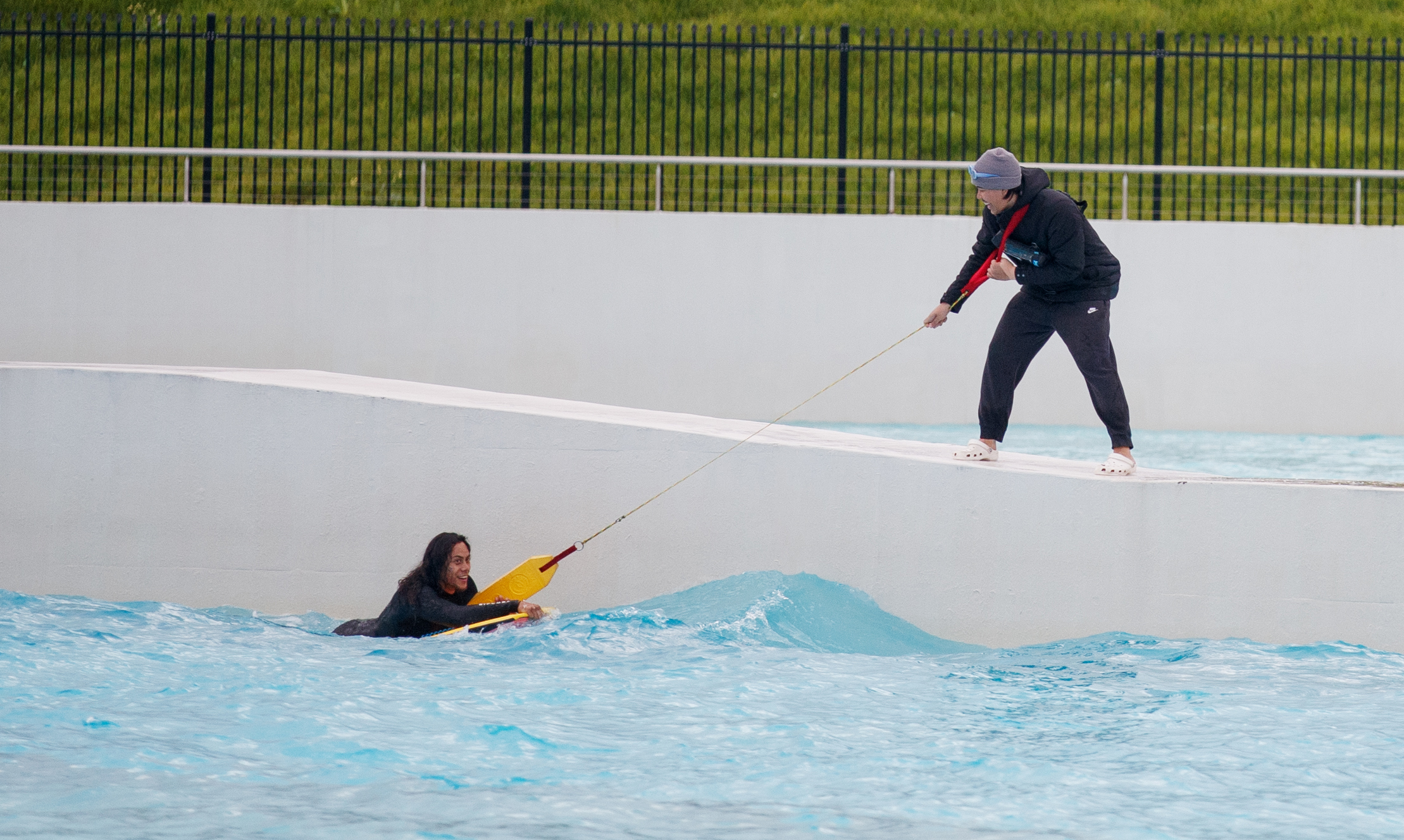 Blues player Jerome Luai is rescued by lifeguards at Urbnsurf.