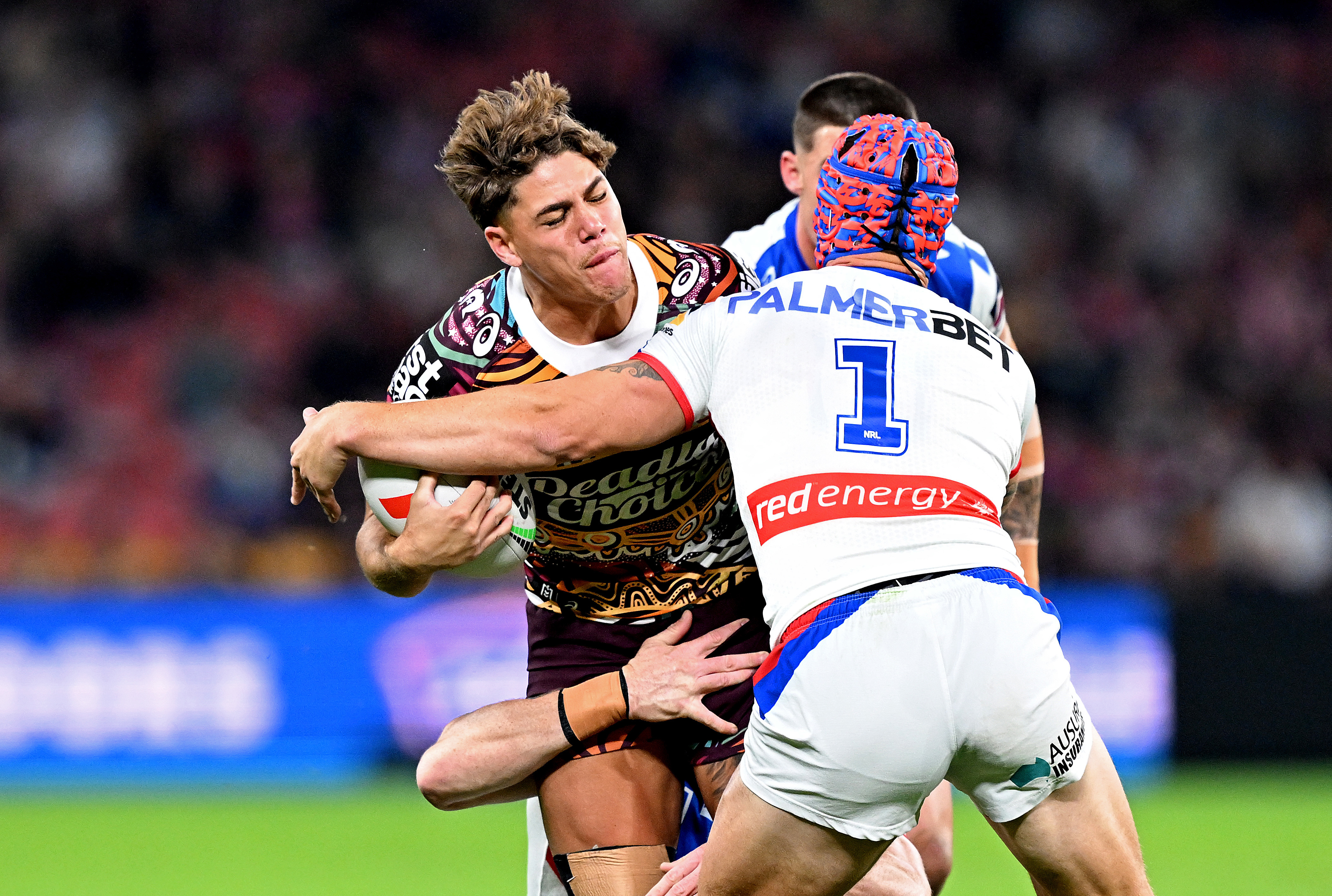 Reece Walsh takes on Kalyn Ponga.